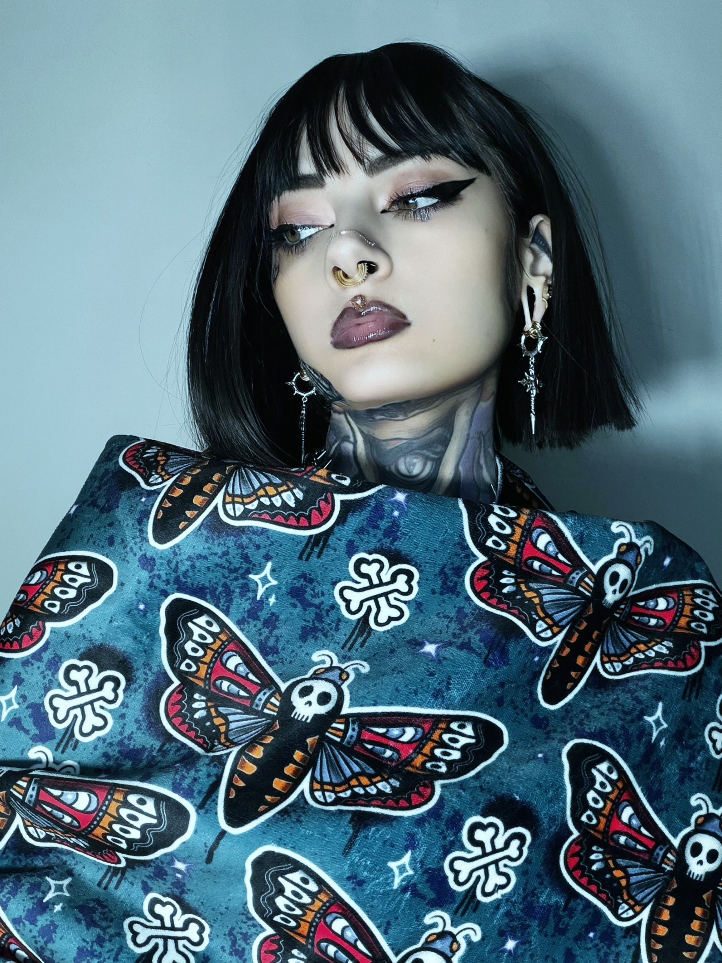 Extra large teal goth moth beach towel made from recycled materials, featuring bold moth graphic on soft fabric.