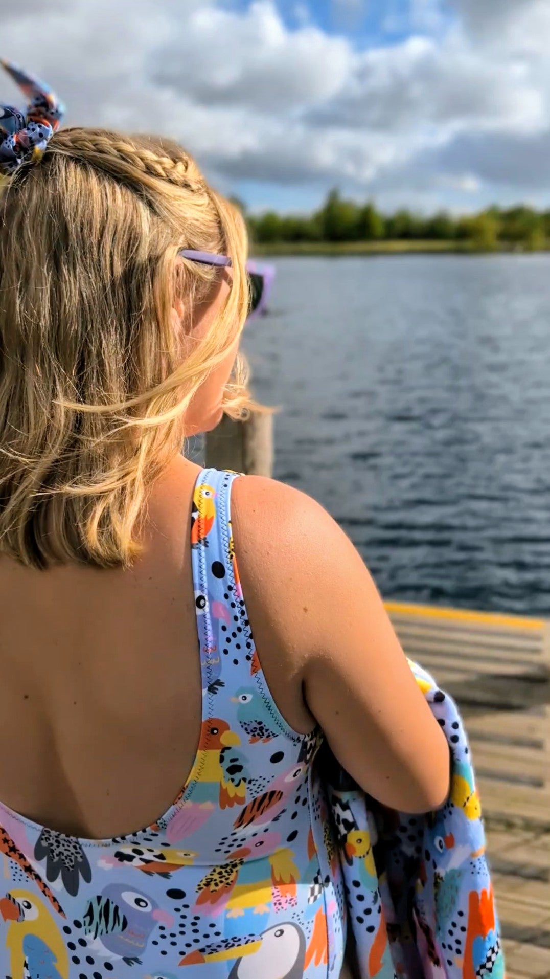 Handmade tropical birds swimsuit by Printful featuring colorful tropical bird print on a UPF 50+ recycled one-piece for all bodies.