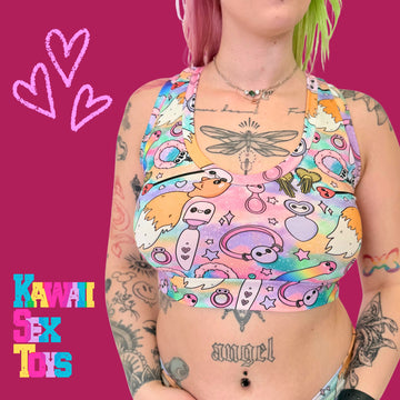 Person wearing a colorful tank top with cartoon designs on a pink background, featuring the text 'Kawaii Sex Toys'.