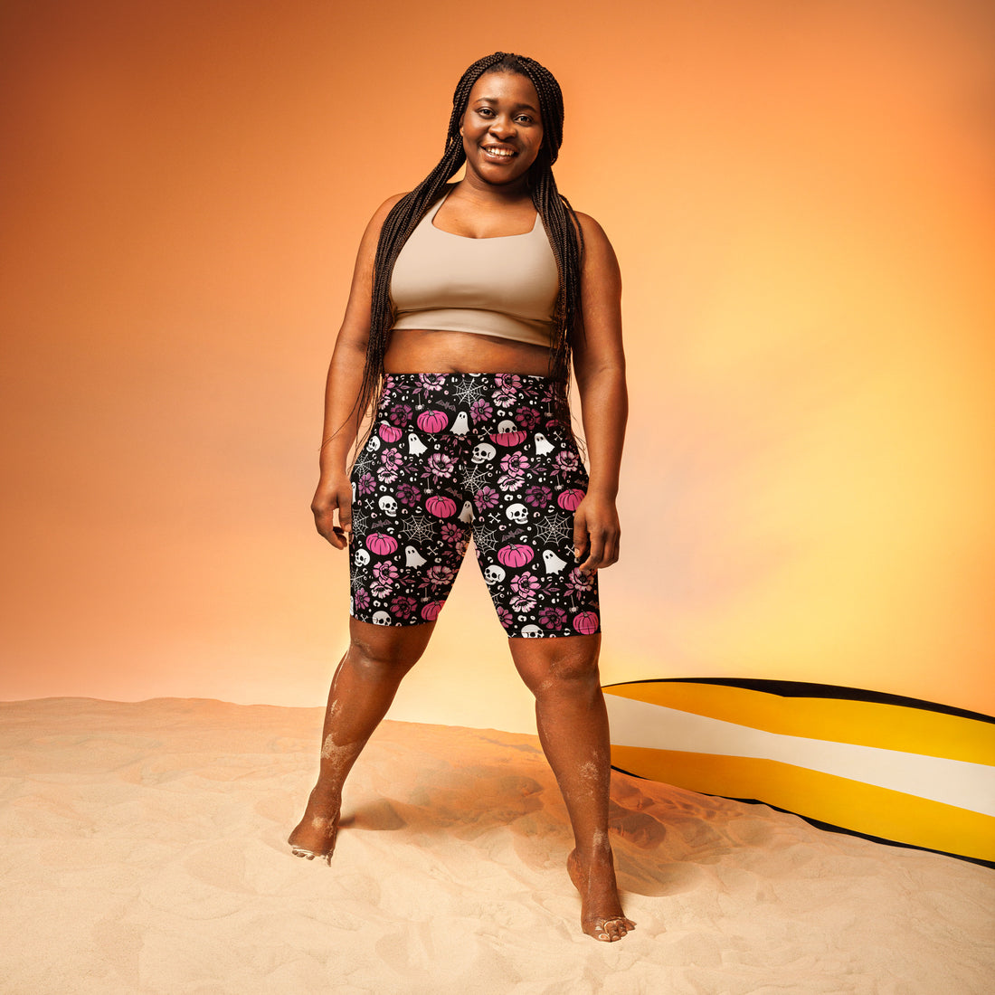 Printful pink Halloween-themed swim biker shorts with all-over print and UPF 50+ sun protection, shown from the front.