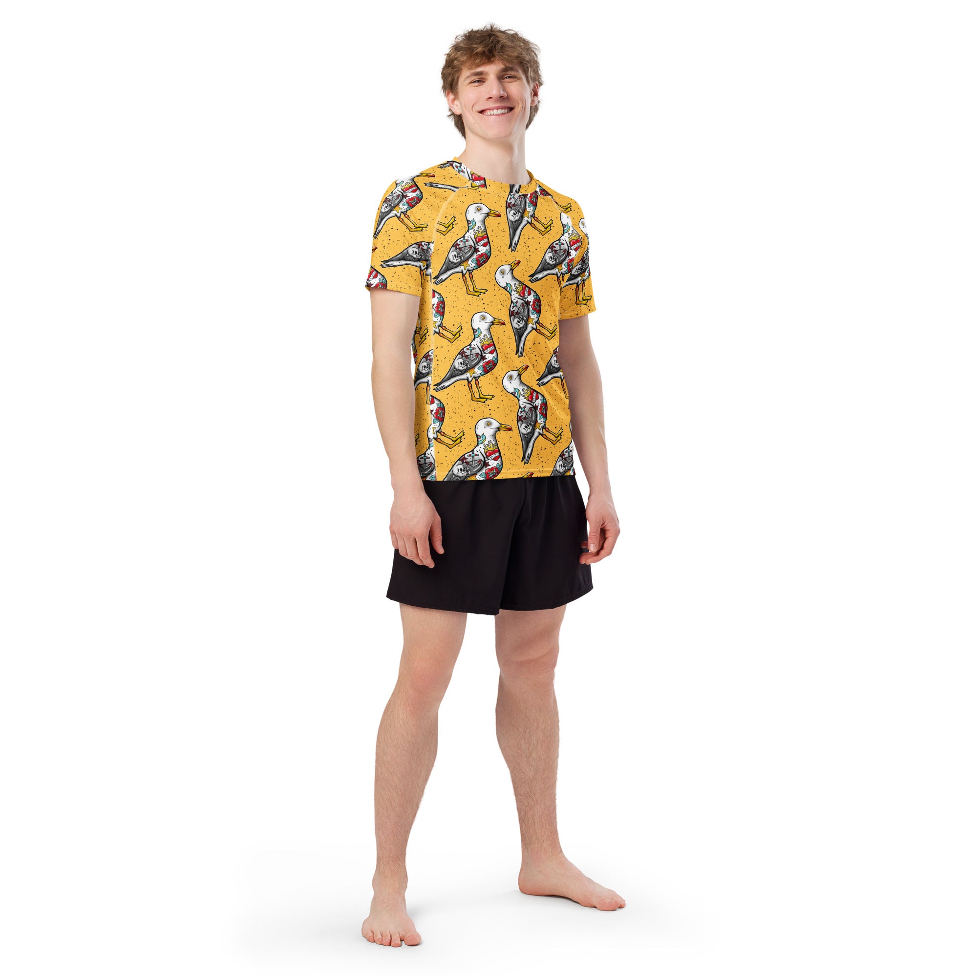 Yellow Nautigul Seagull print unisex short sleeve rash guard by Printful, with all-over seagull design on recycled fabric.