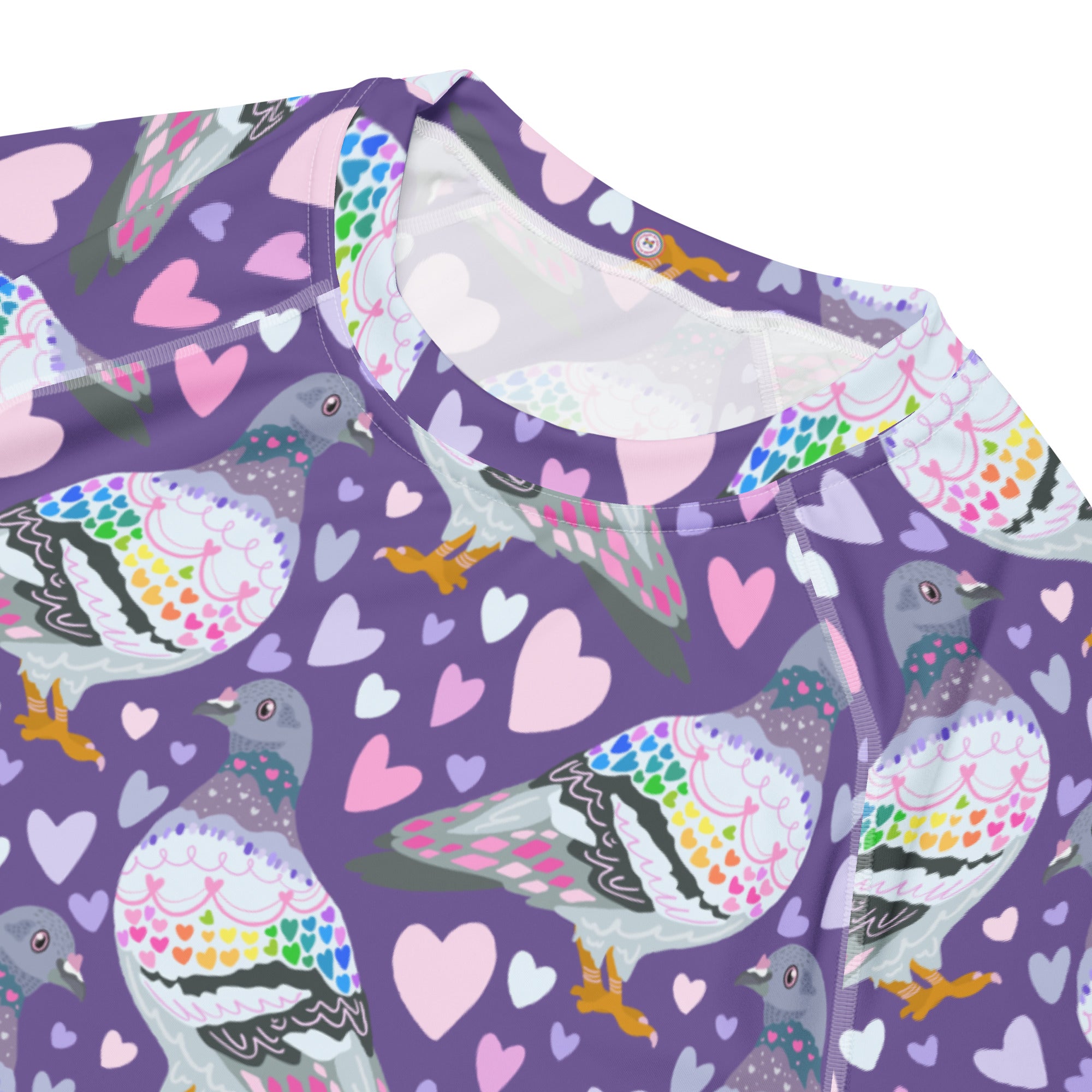 White unisex rash guard with colorful pigeon love all-over print, short sleeves, made from recycled materials by Printful.