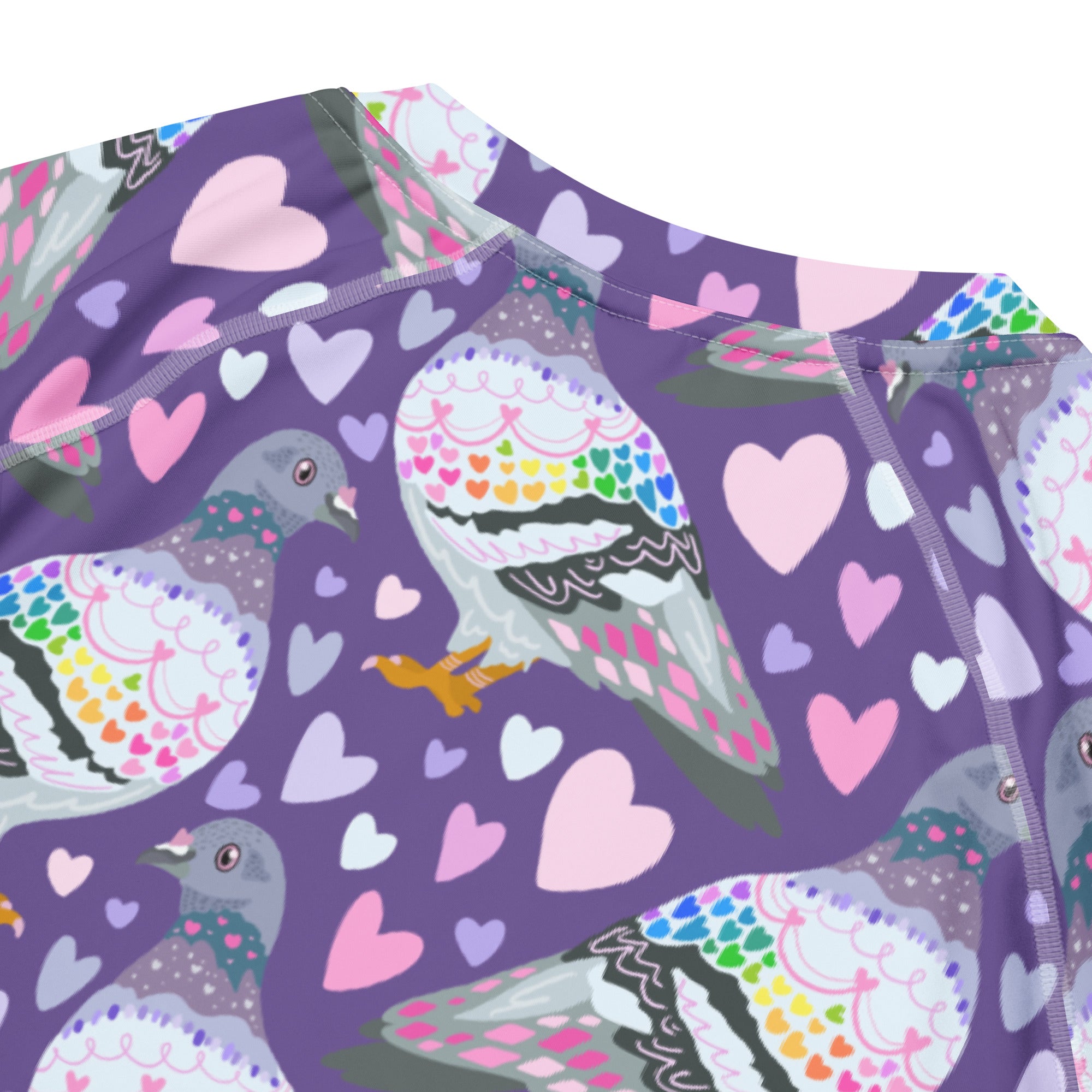 White unisex rash guard with all-over pigeon love print, featuring short sleeves and recycled fabric by Printful.