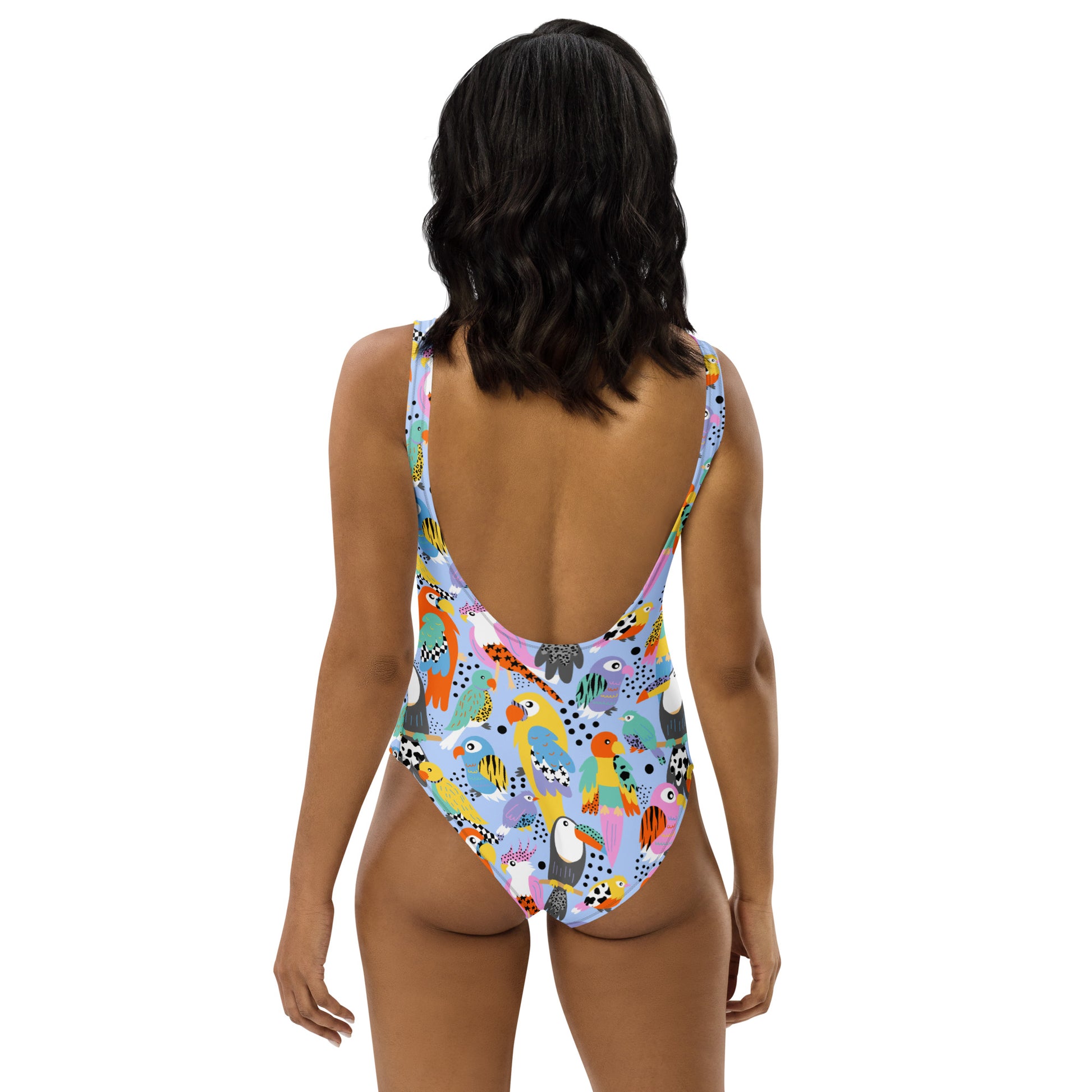 Handmade tropical birds swimsuit by Printful, all-over-print white one-piece with UPF 50+ sun protection for all bodies.