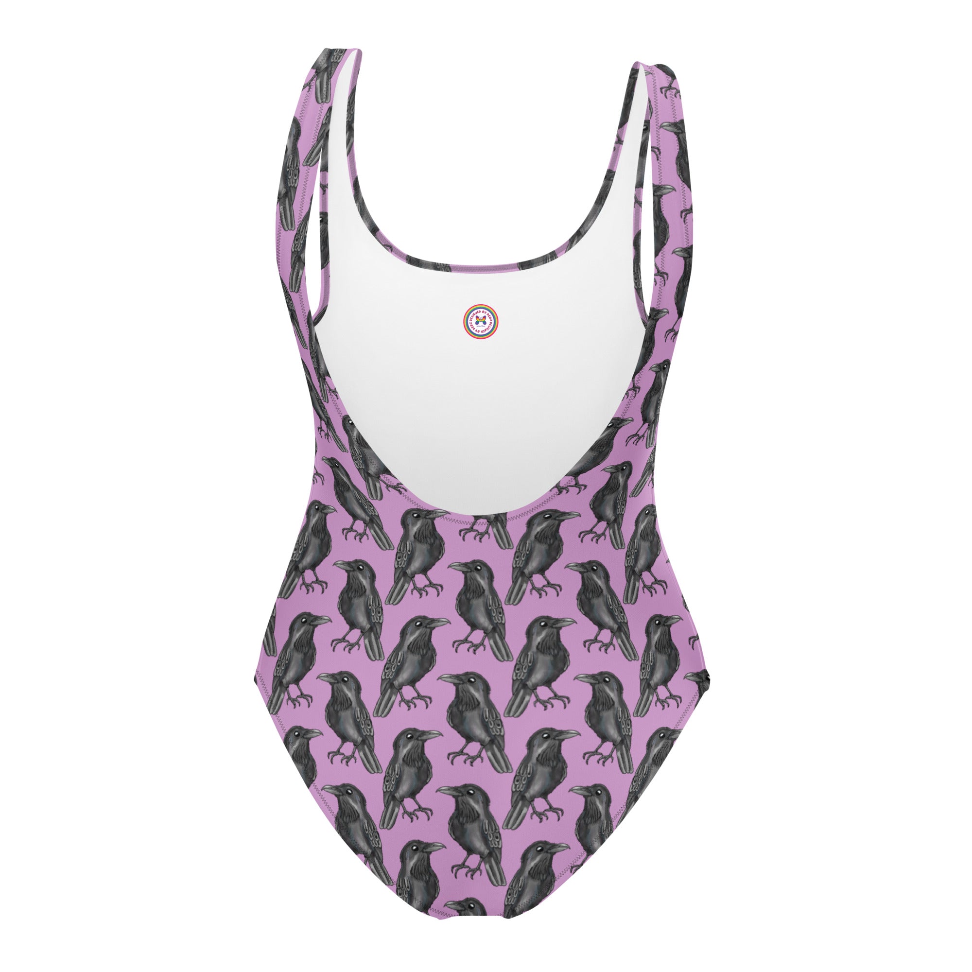 Lilac one-piece swimsuit with gothic crow print by Printful, featuring an all-over black crow design on white background.