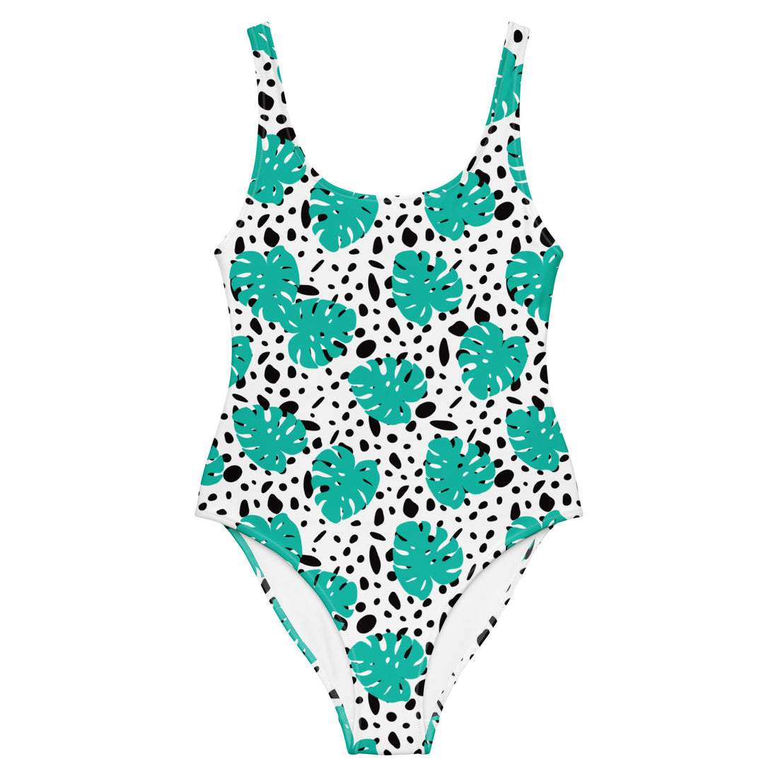 A one-piece swimsuit with a white base, decorated with a pattern of teal monstera leaves and black irregular spots, shown against a plain white background.