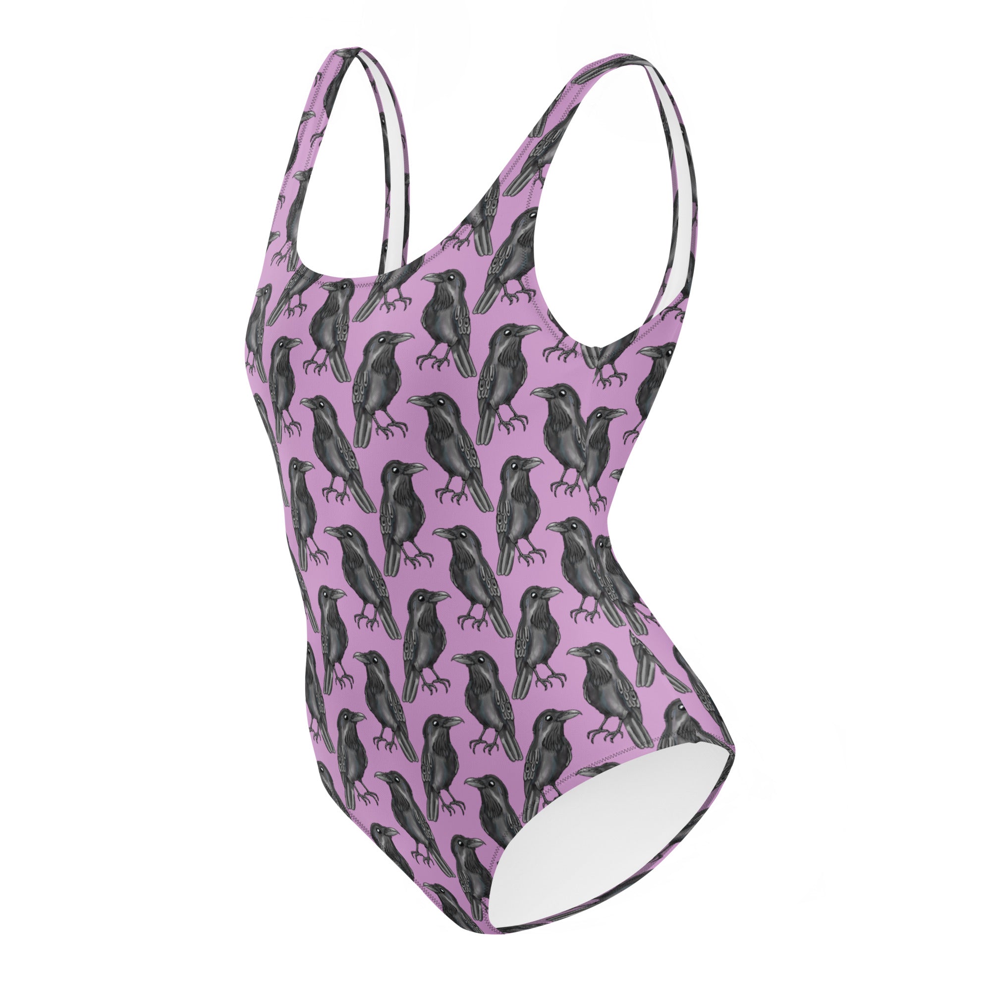 Lilac one-piece swimsuit with a gothic crow print from Printful featuring an all-over black crow design on white background.