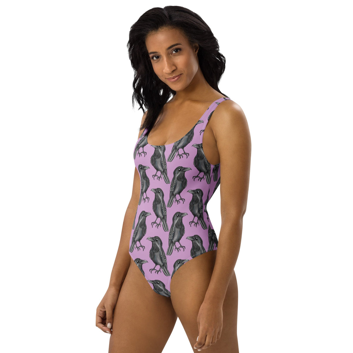 Lilac one-piece swimsuit with gothic crow print from Printful, featuring all-over black crow design on white background.