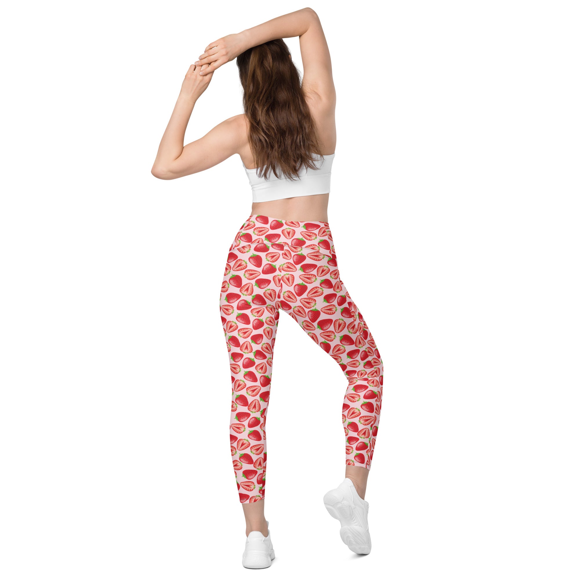 Printful crossover leggings with wild strawberry print, featuring pockets and a recycled fabric design, shown from the back.