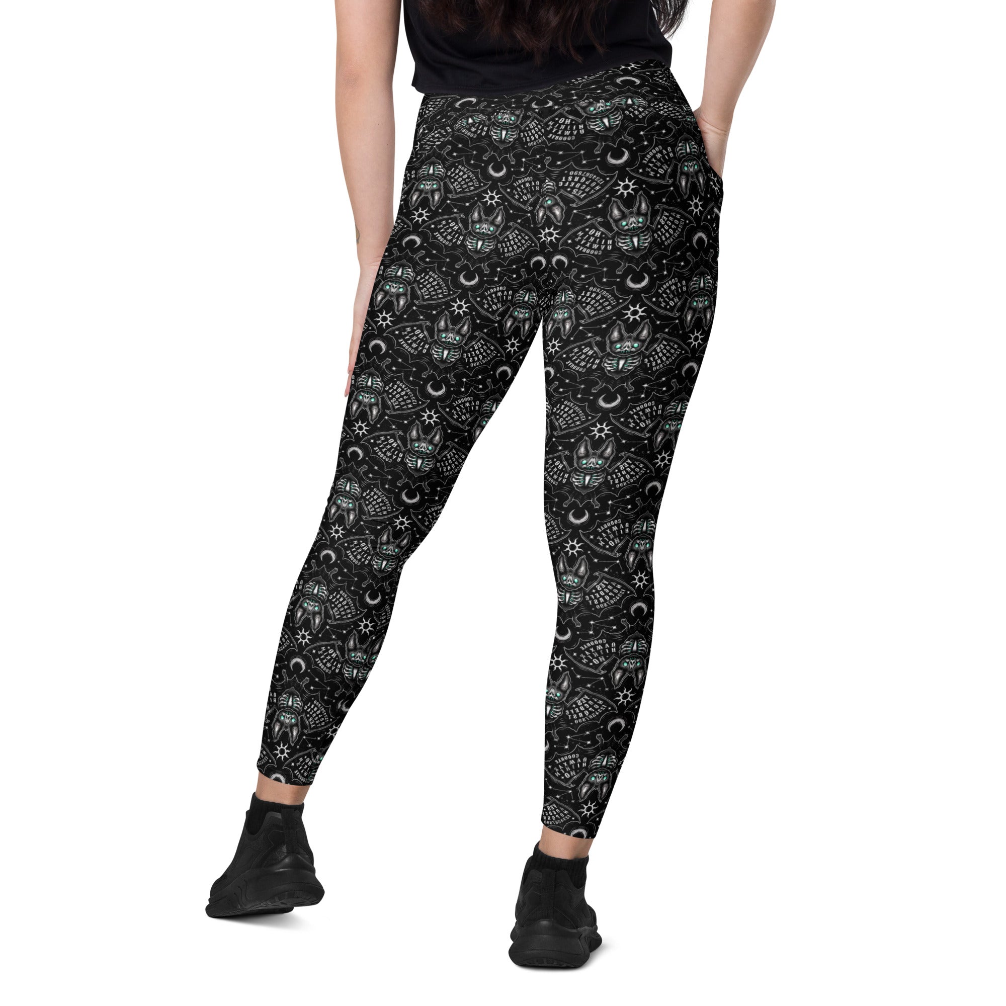 Printful Ouija Bats crossover leggings with pockets featuring all-over white bat print on recycled fabric.