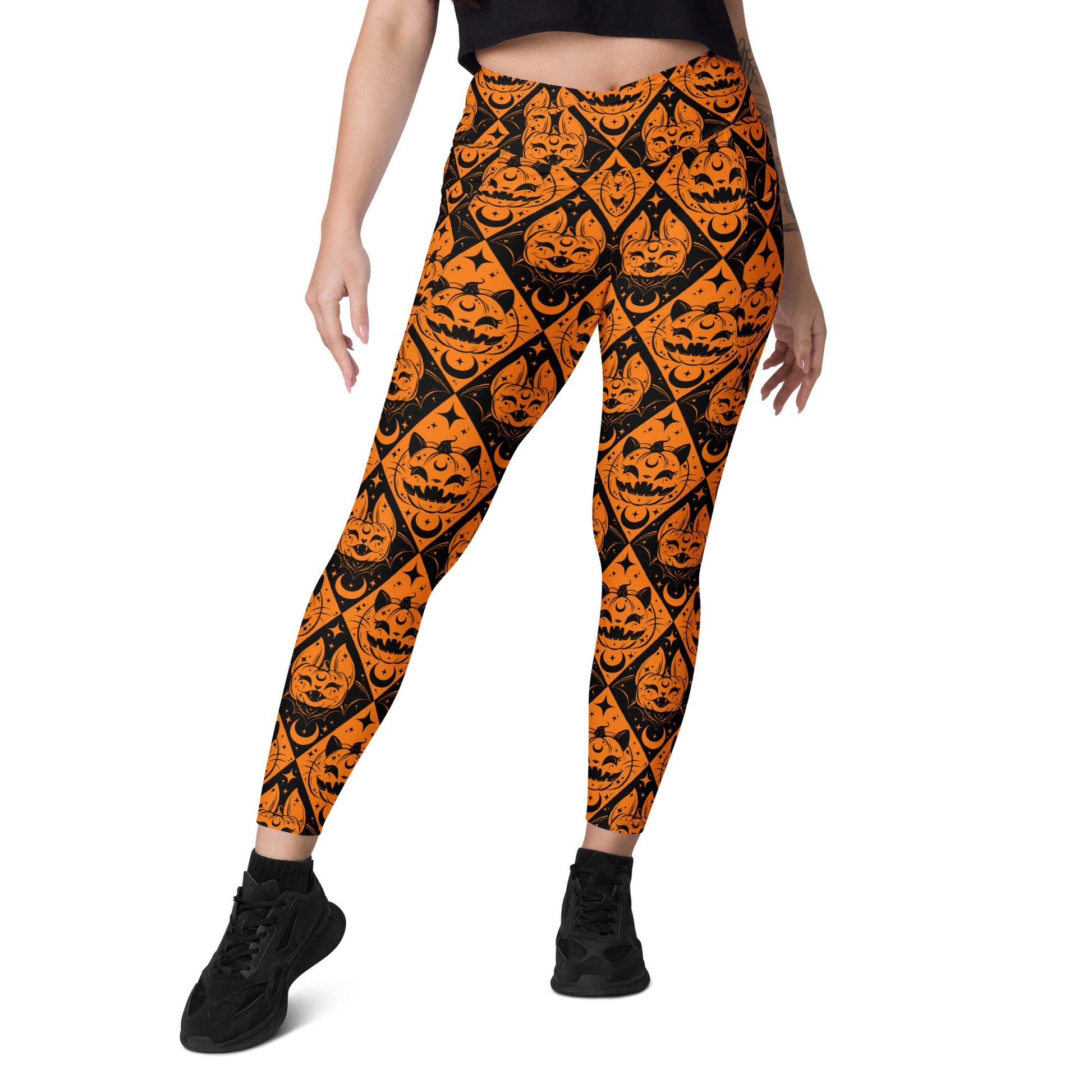 Printful Halloween cat and pumpkin crossover leggings with pockets, featuring all-over spooky-themed print on white background.