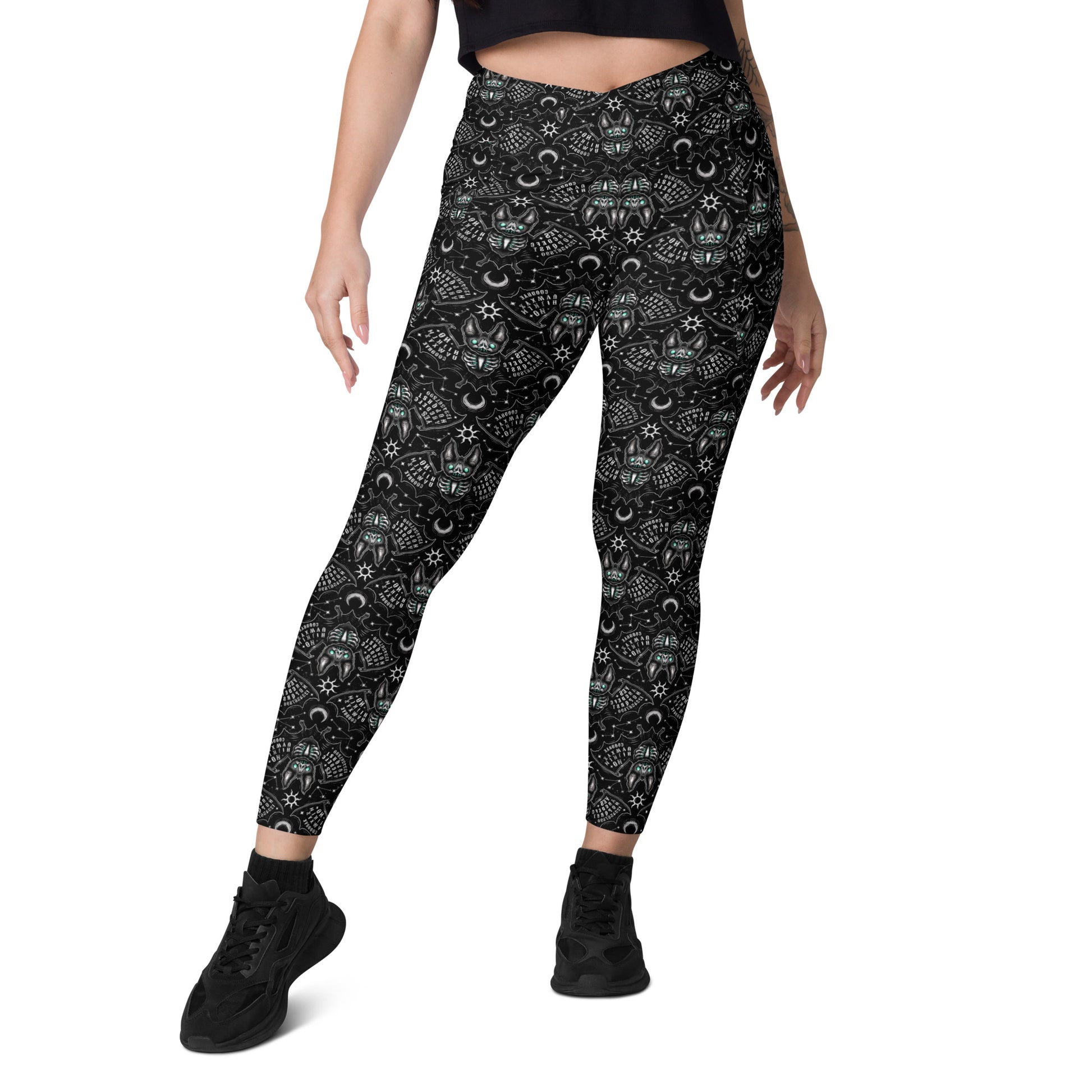 White Ouija Bats crossover leggings with pockets from Printful, featuring all-over bat and Ouija board print on stretchy fabric.