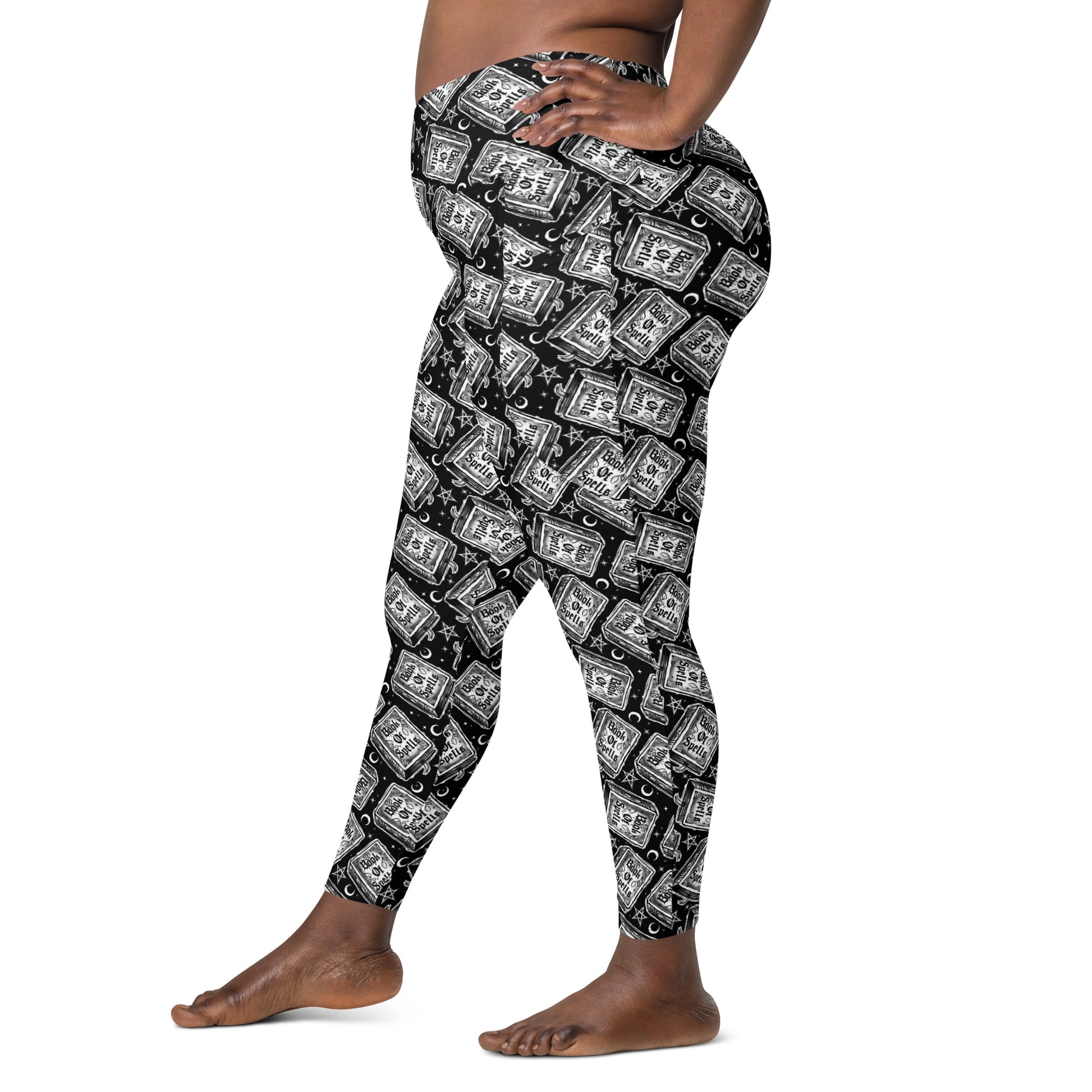 Printful Book of Spells crossover leggings with pockets featuring all-over magical spell print on white background.