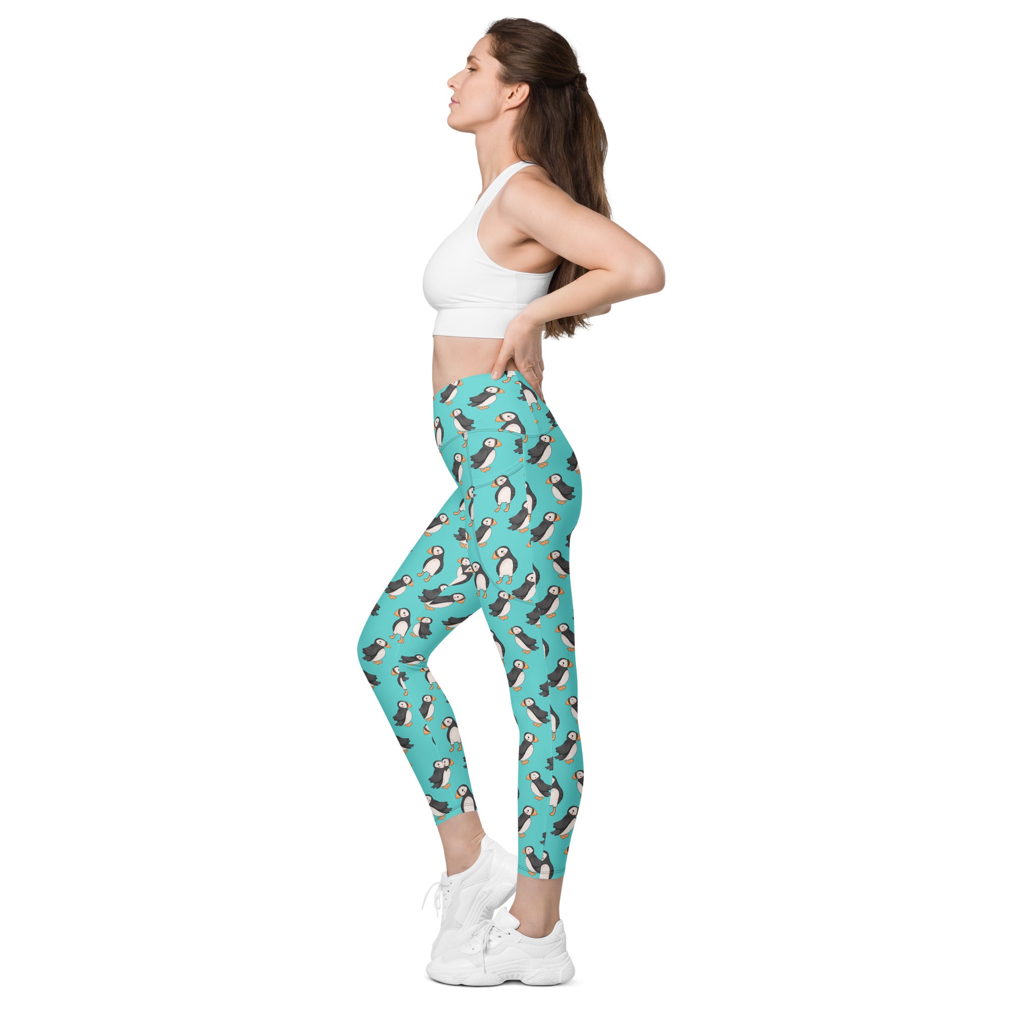 Printful Puffin Party crossover leggings with pockets featuring an all-over white and colorful puffin print.