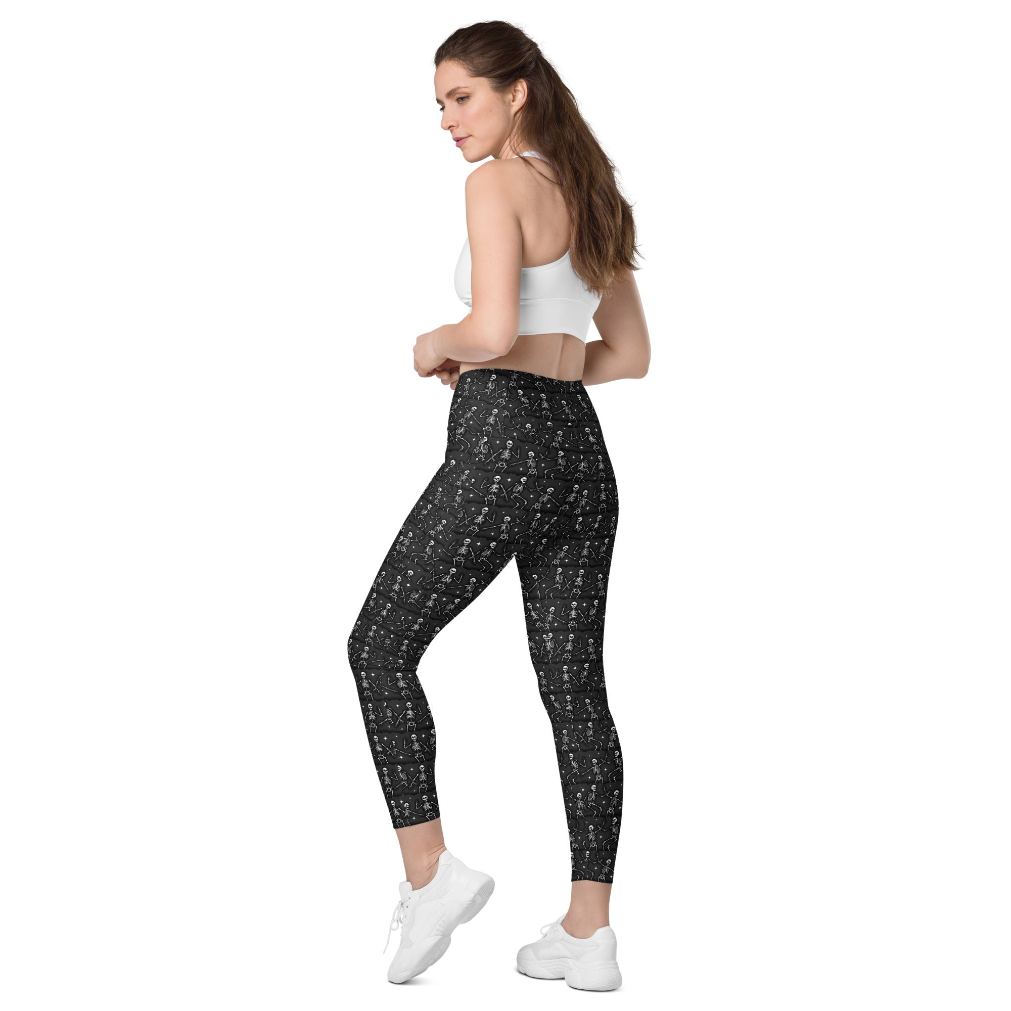 Printful DBD x Waffle Mamma Bone Dance crossover leggings with all-over print, pockets, white background, back view.