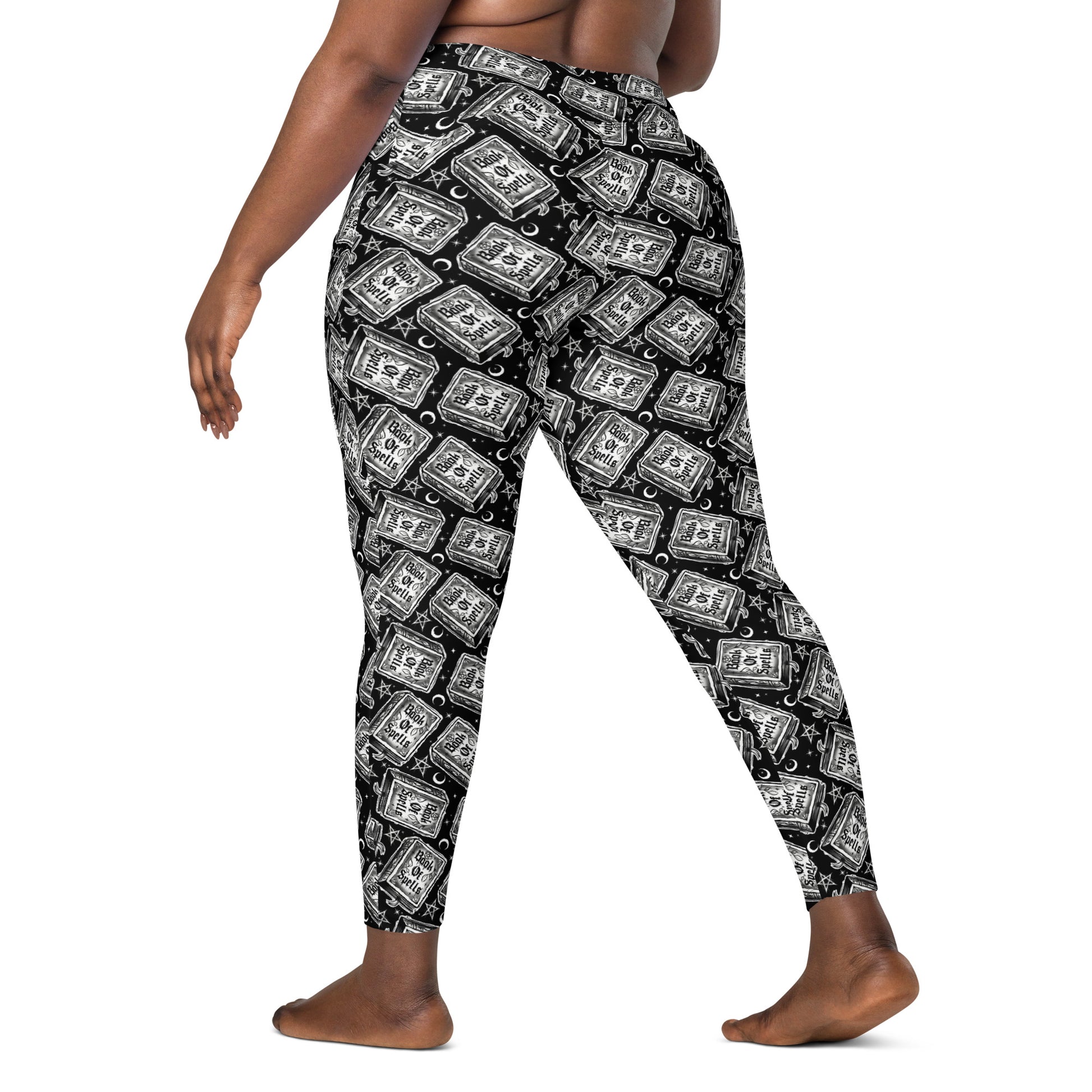 Printful Book of Spells crossover leggings with pockets, all-over printed in white, featuring a magical spell design and comfortable fit.
