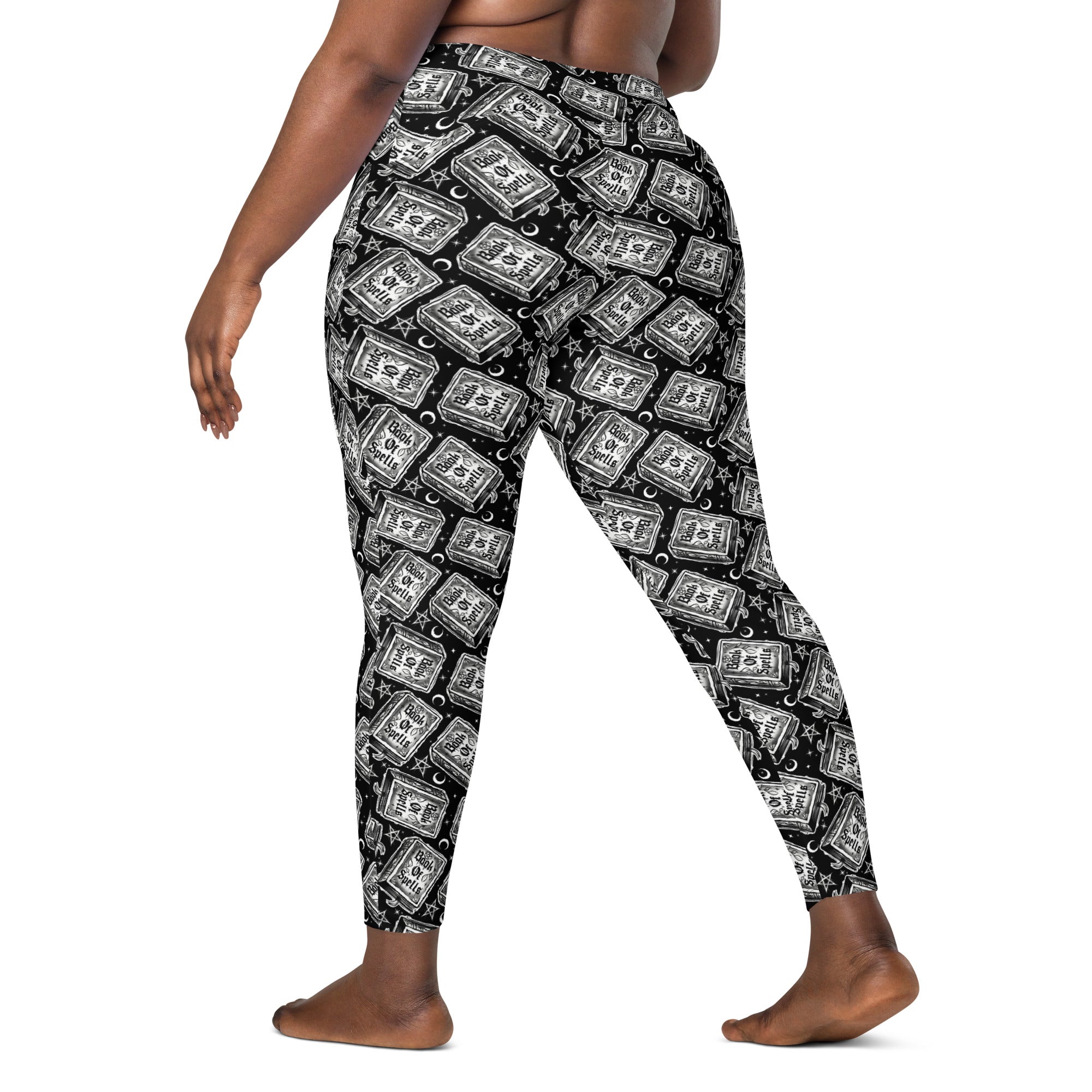 Printful Book of Spells crossover leggings with pockets, all-over printed in white, featuring a magical spell design and comfortable fit.