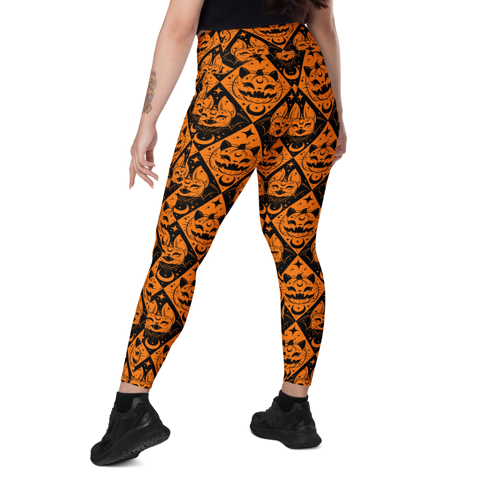 Printful Halloween cat and pumpkin crossover leggings with pockets, all-over print in white and black, featuring festive spooky designs.