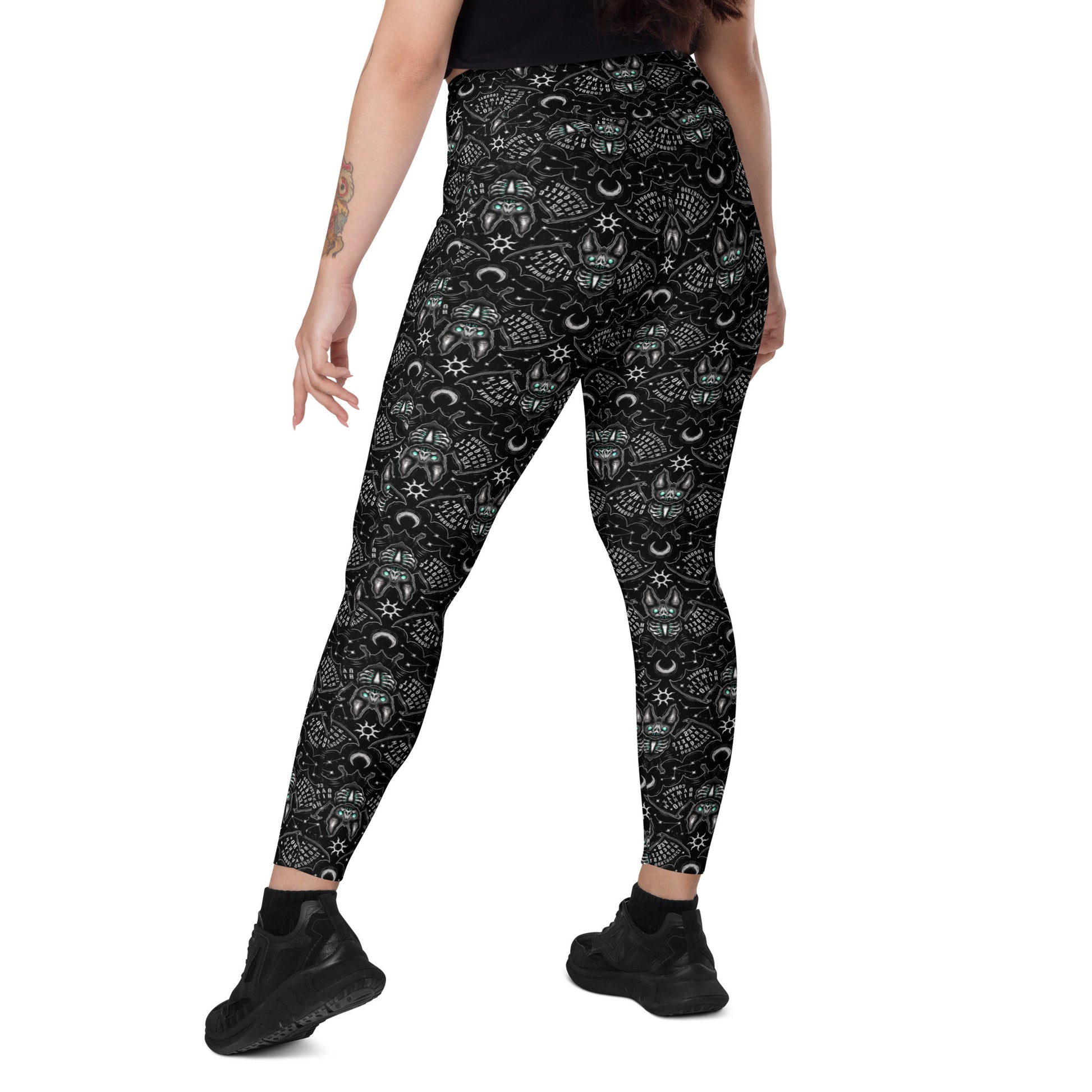 Printful Ouija Bats crossover leggings with pockets, all-over white print, featuring bat and Ouija design on stretchy fabric.