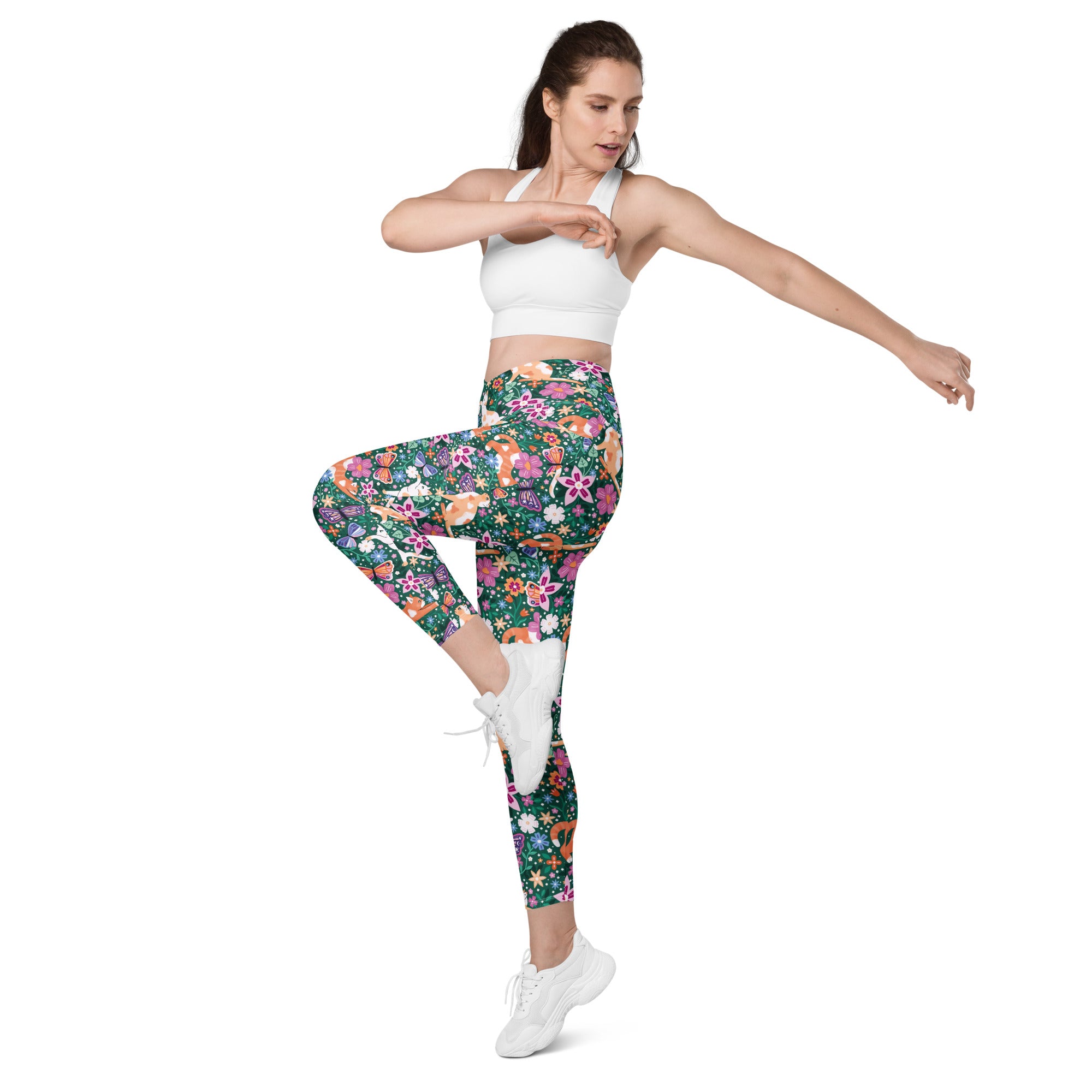Printful Garden Familiar Cat crossover leggings with pockets, featuring an all-over white floral and cat print, front view.