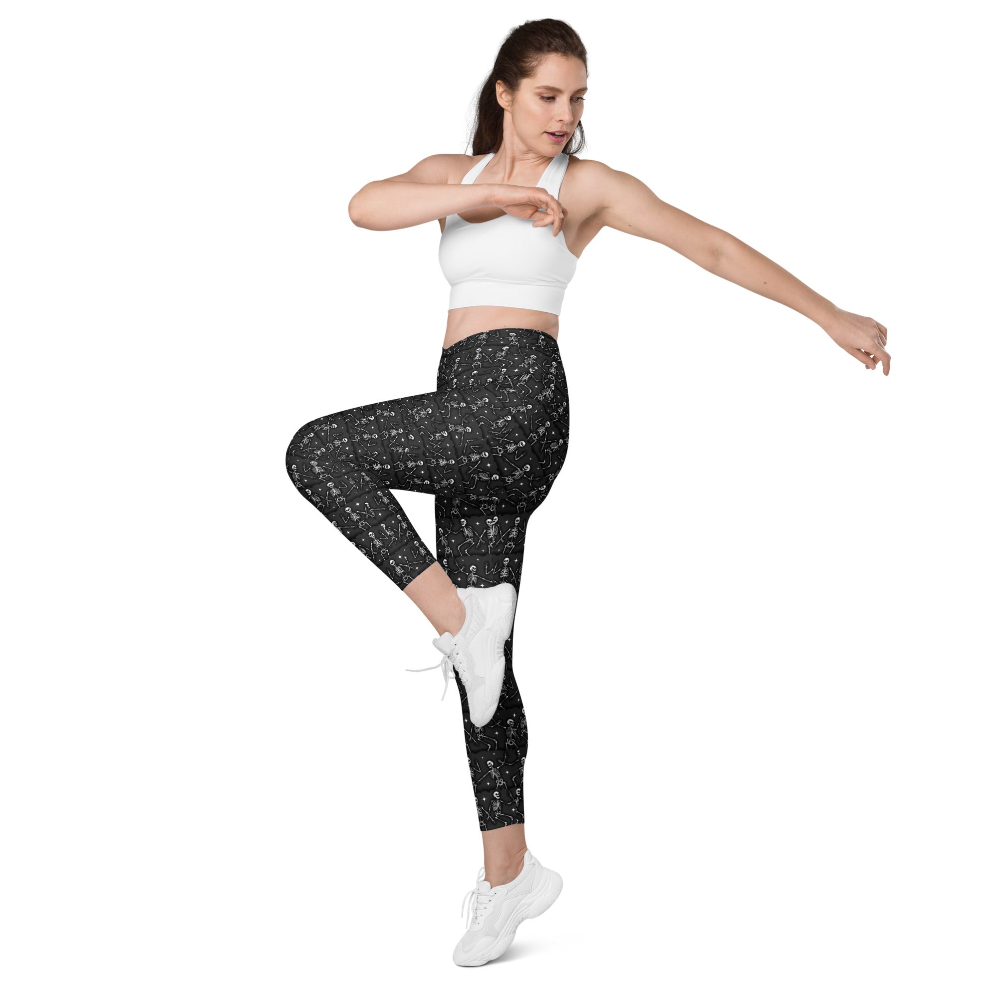 Printful DBD x Waffle Mamma Bone Dance crossover leggings with all-over white print and side pockets, front view.