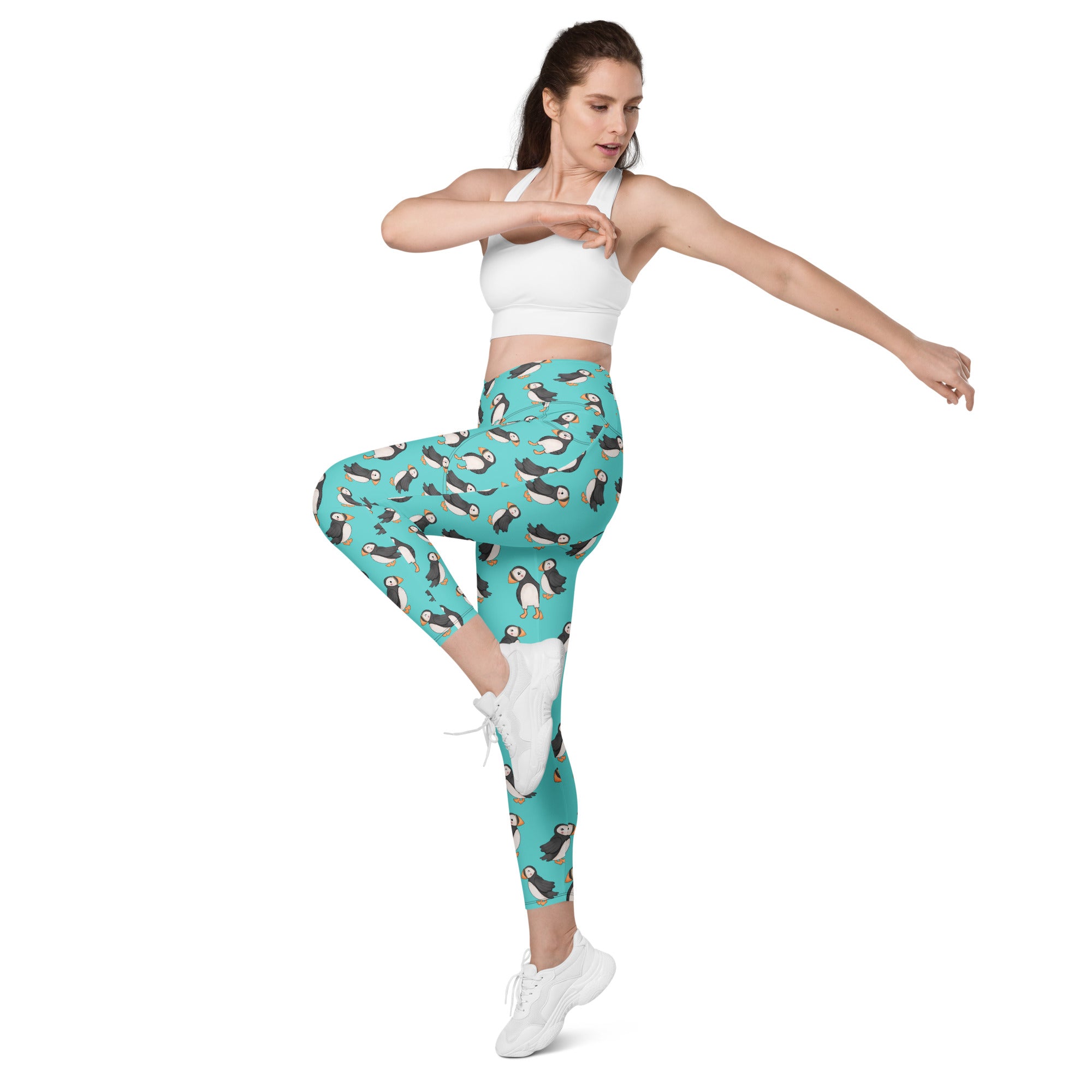 Printful Puffin Party crossover leggings with pockets featuring a colorful all-over puffin print on white fabric.