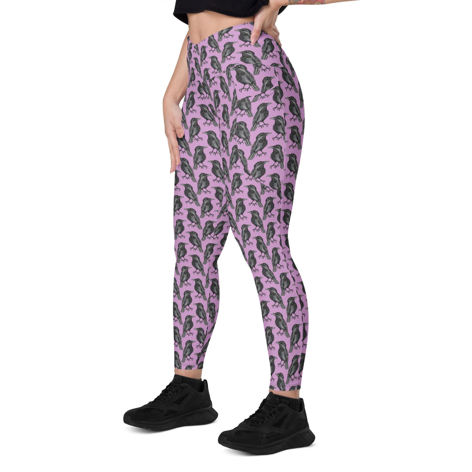 Printful Murder of Crows crossover leggings with pockets featuring an all-over black and white crow pattern, front view.