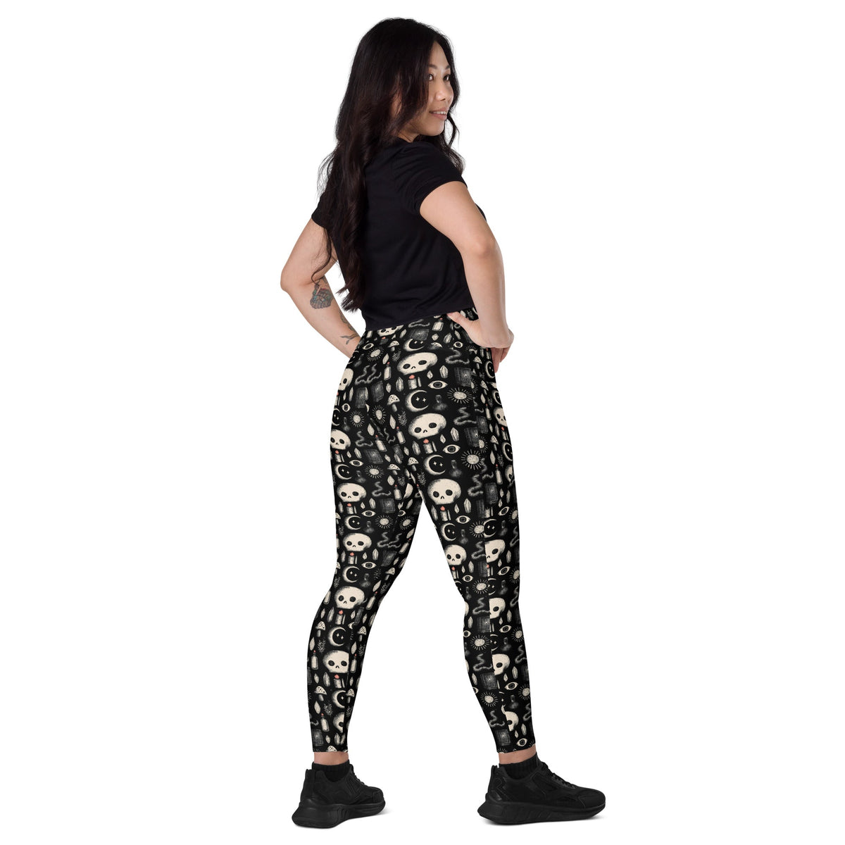 Dark occult crossover leggings with pockets featuring an all-over white print, made by Printful.