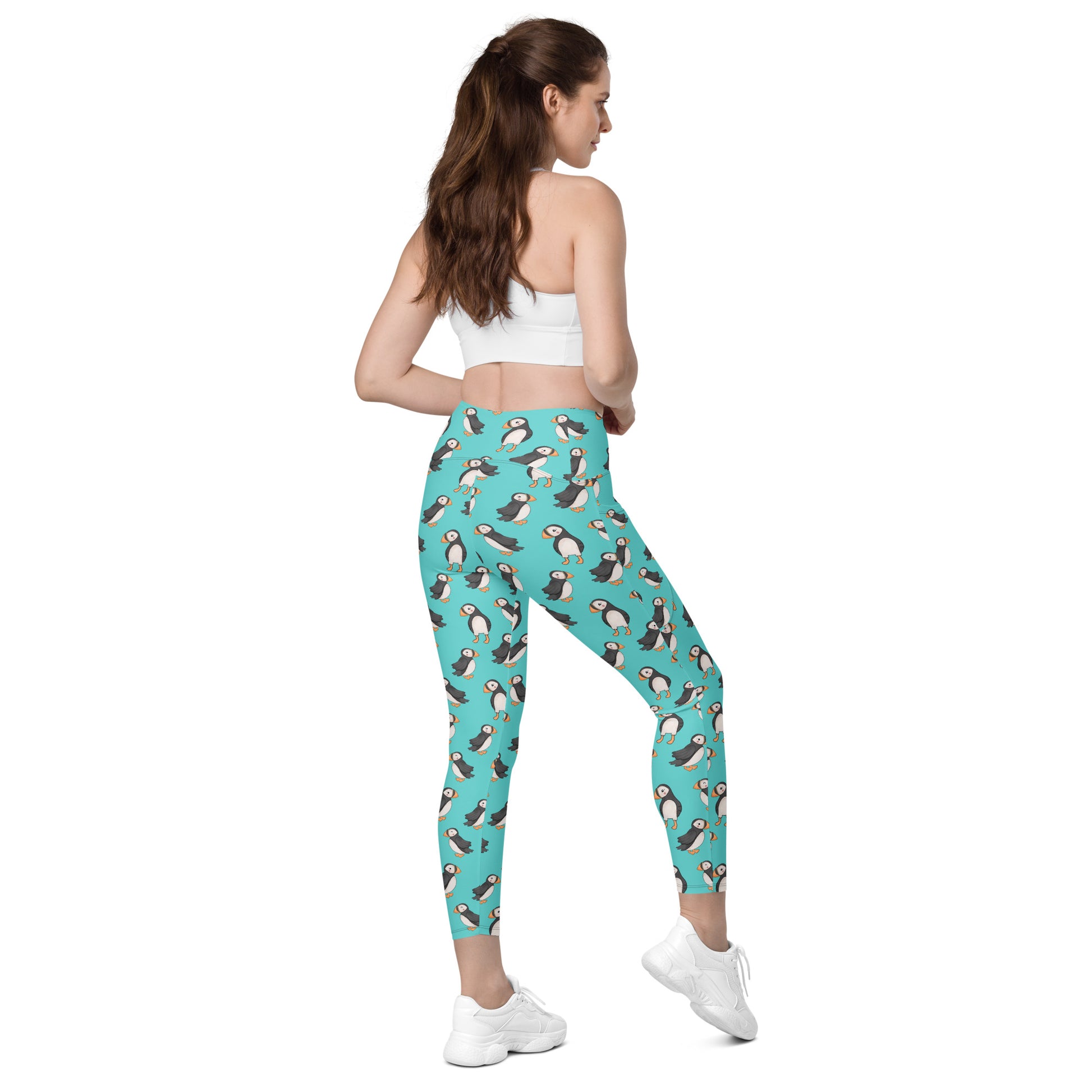 Printful Puffin Party crossover leggings with all-over print, featuring pockets and a white background, shown from the right back angle.