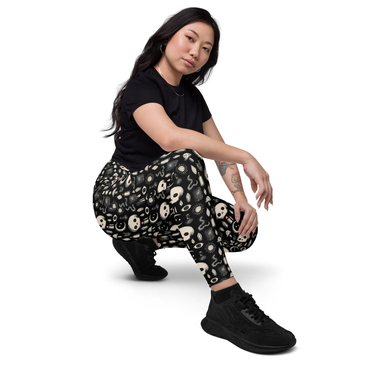 Dark occult crossover leggings with pockets featuring an all-over white print, made from recycled materials, by Printful.