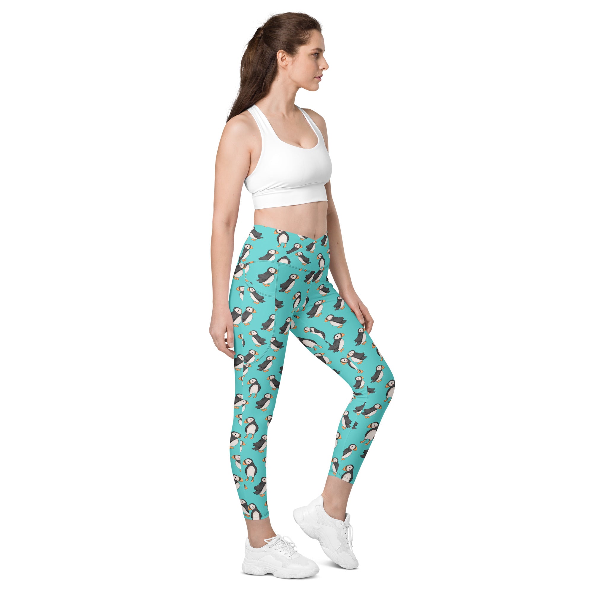 Printful Puffin Party crossover leggings with all-over print and pockets, featuring a vibrant white design and comfortable fit.