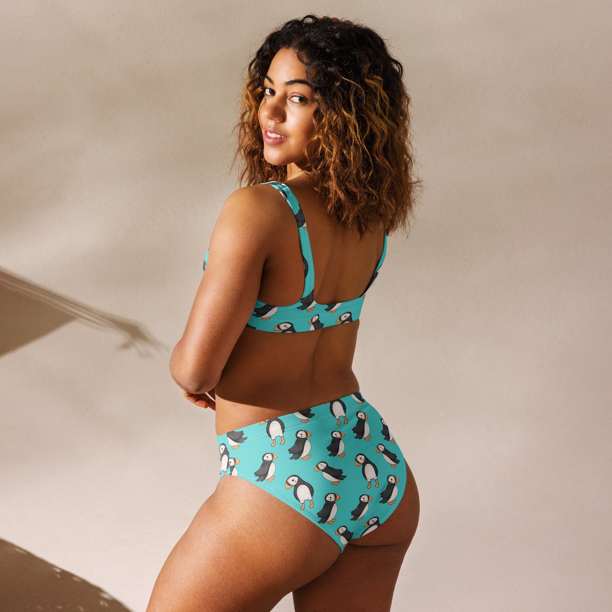 Recycled high-waisted bikini with puffin print in electric blue, showing back view, designed by Printful in size XS-3XL.