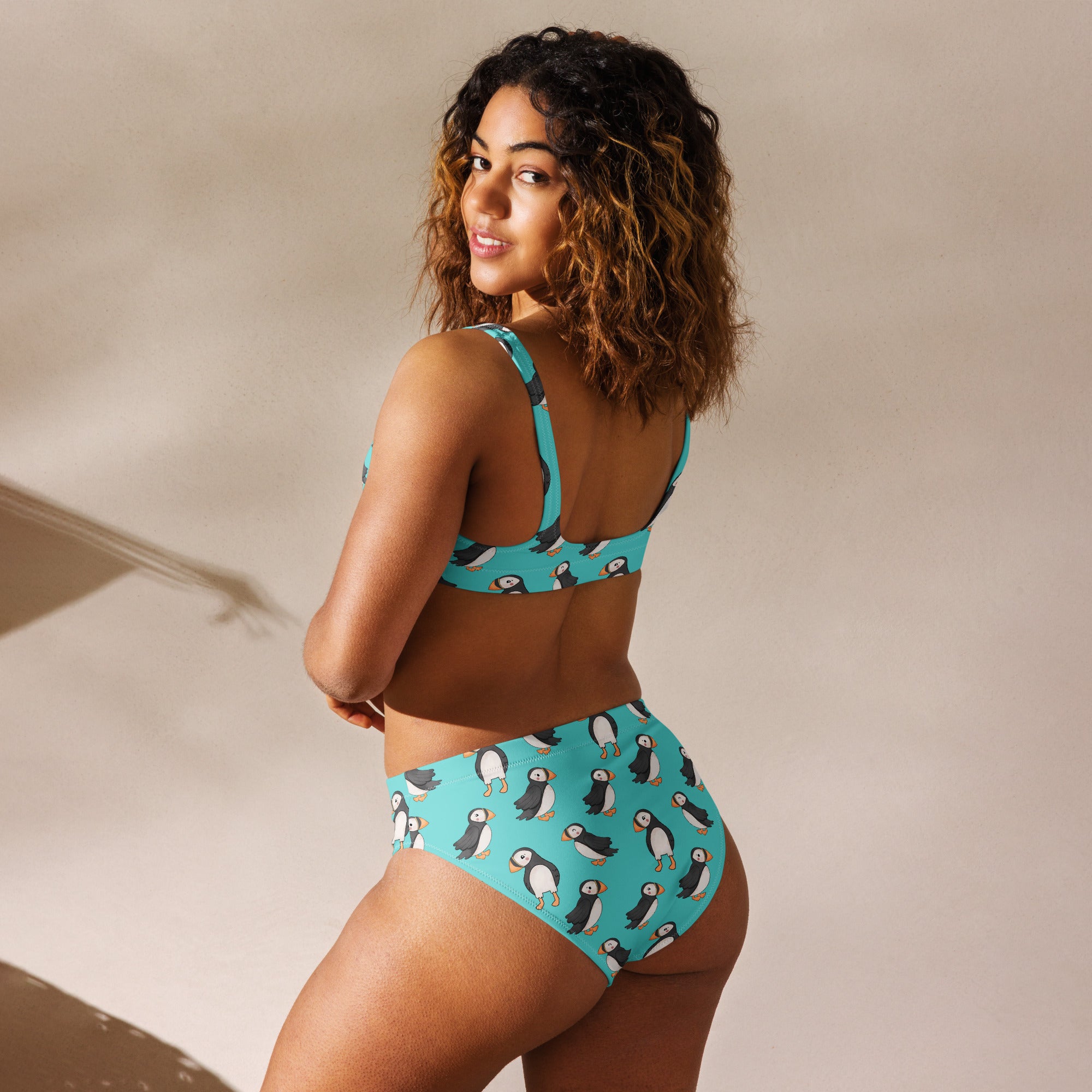 Recycled high-waisted bikini with puffin print in electric blue, showing back view, designed by Printful in size XS-3XL.