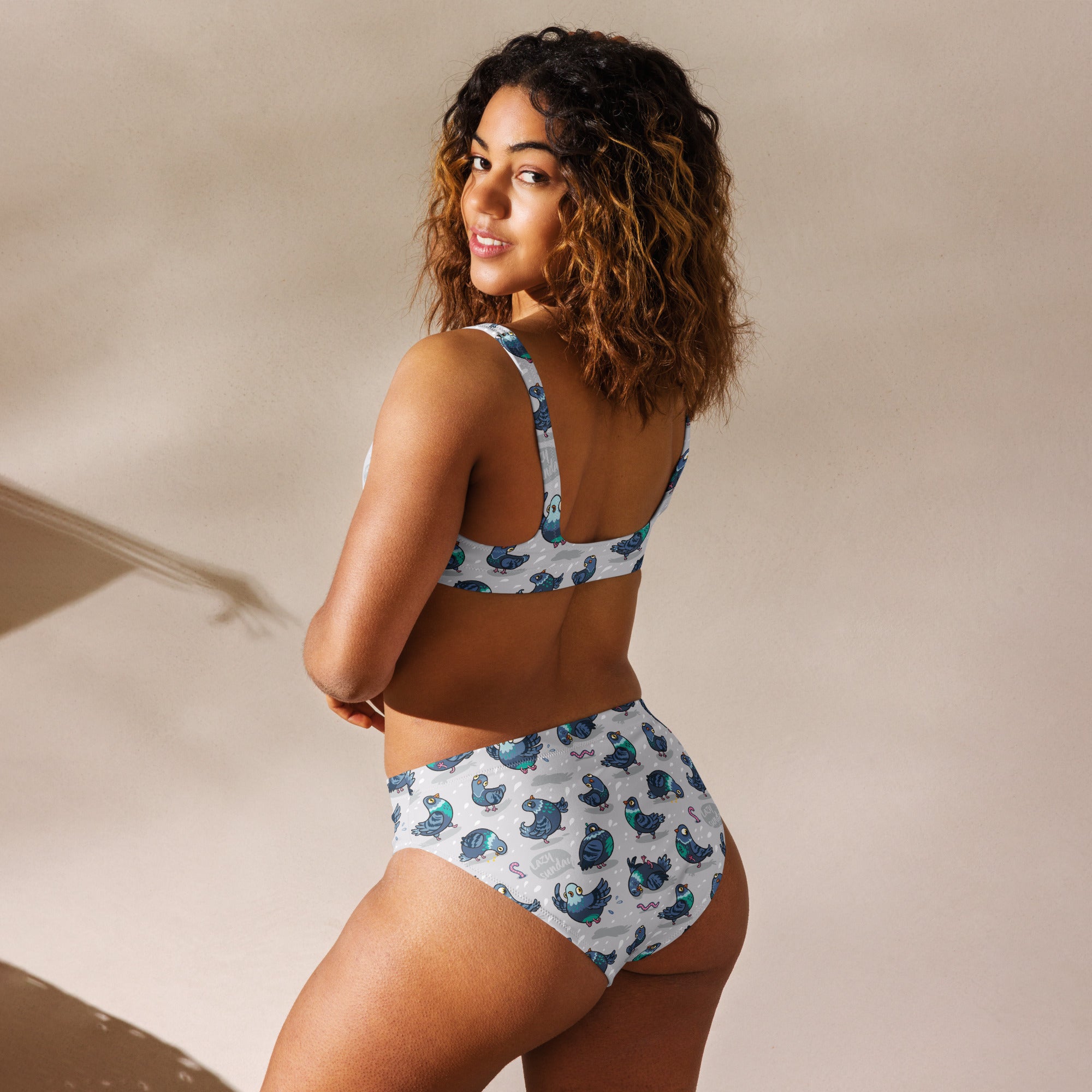 Recycled high-waisted bikini with Silly Pigeons print in white, featuring a full-coverage back and vibrant all-over design.
