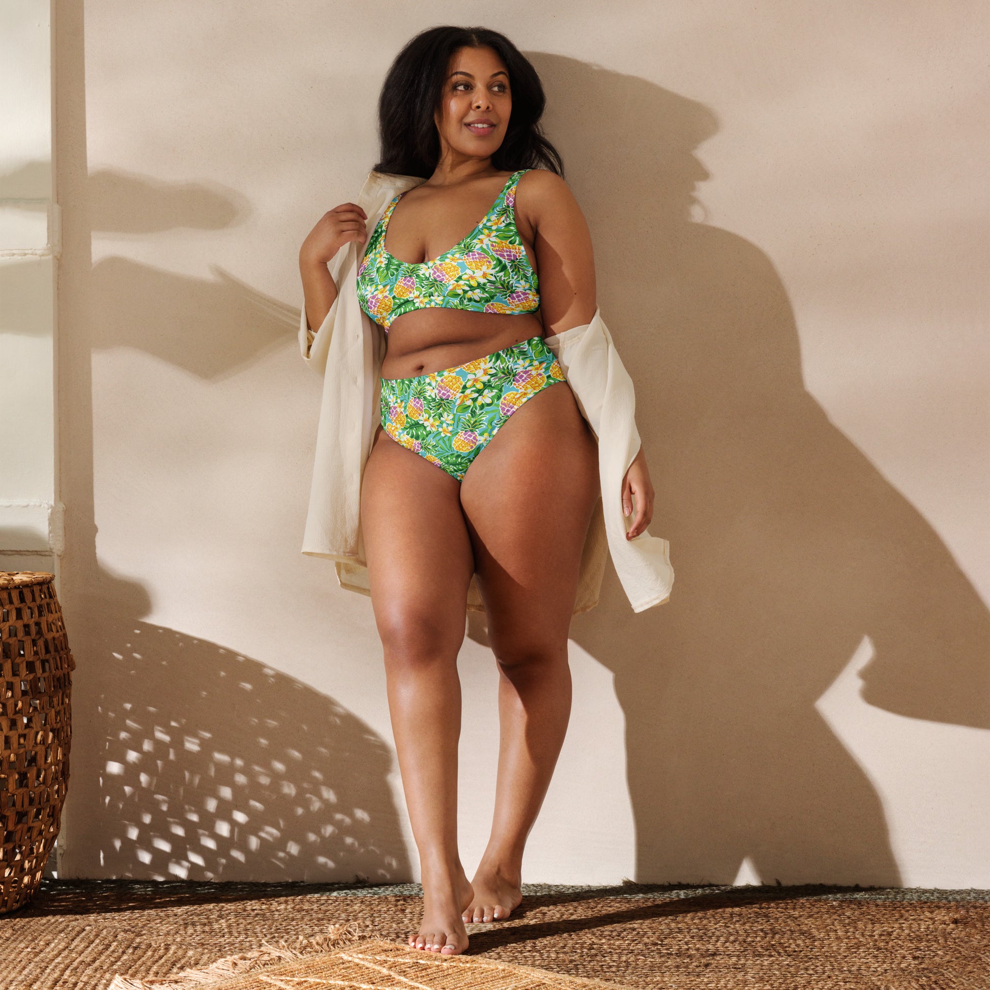 Recycled high-waisted bikini in green with pineapple and flower print, front view, showcasing all-over tropical design.