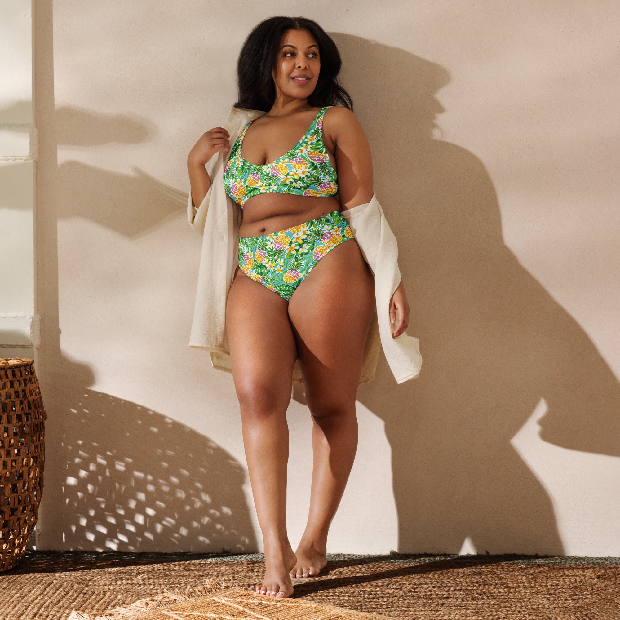 Recycled high-waisted bikini in green with pineapple and flower print, front view, showcasing all-over tropical design.