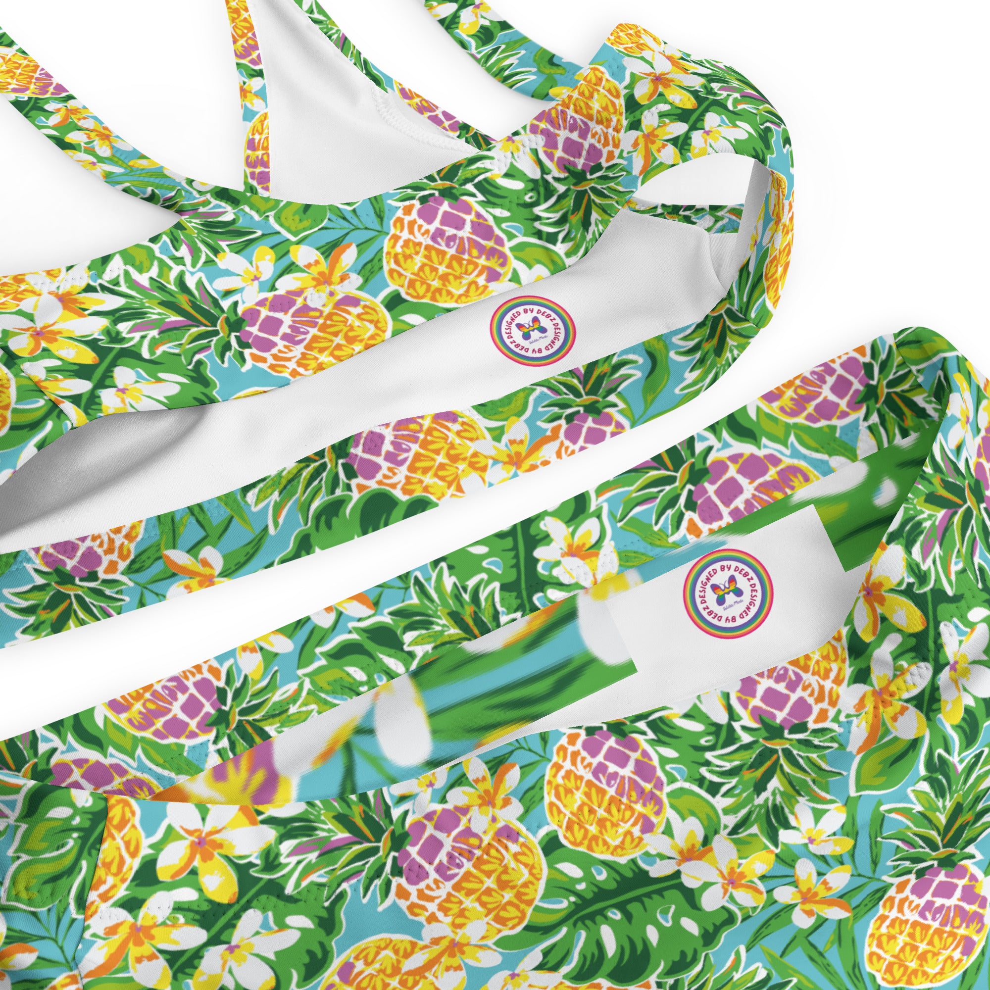 Recycled high-waisted bikini in green with pineapple and flower print, featuring a vibrant all-over pattern and a comfortable fit.