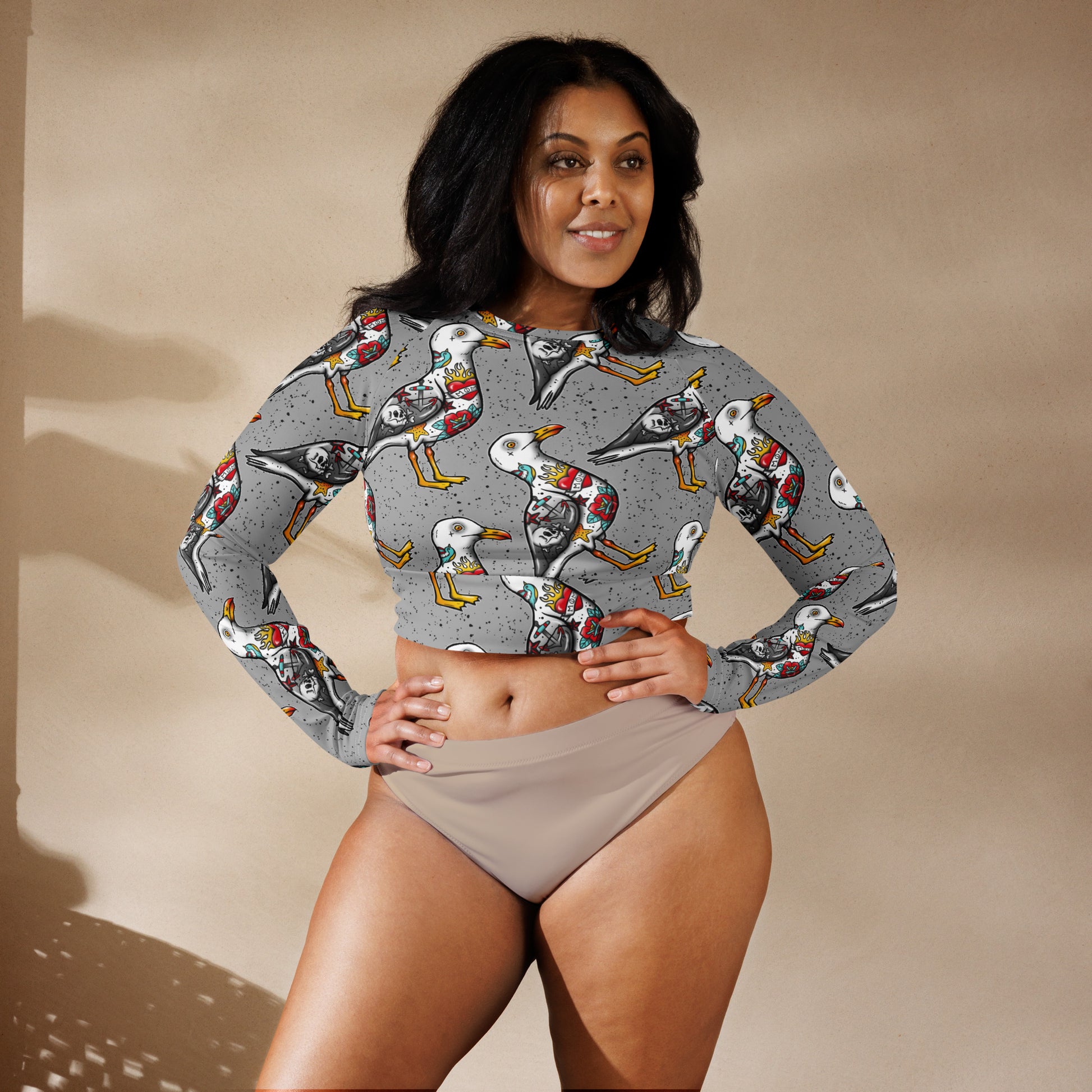 Grey Nautigul Seagull tattoo print recycled long-sleeve crop top with all-over seagull design on white fabric.