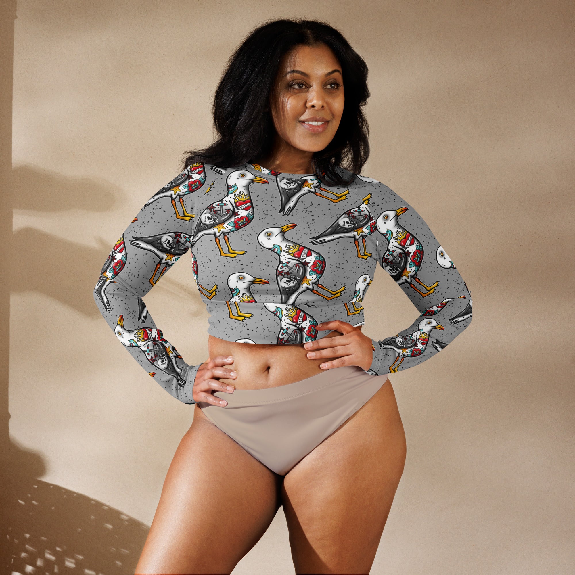 Grey Nautigul Seagull tattoo print recycled long-sleeve crop top with all-over seagull design on white fabric.