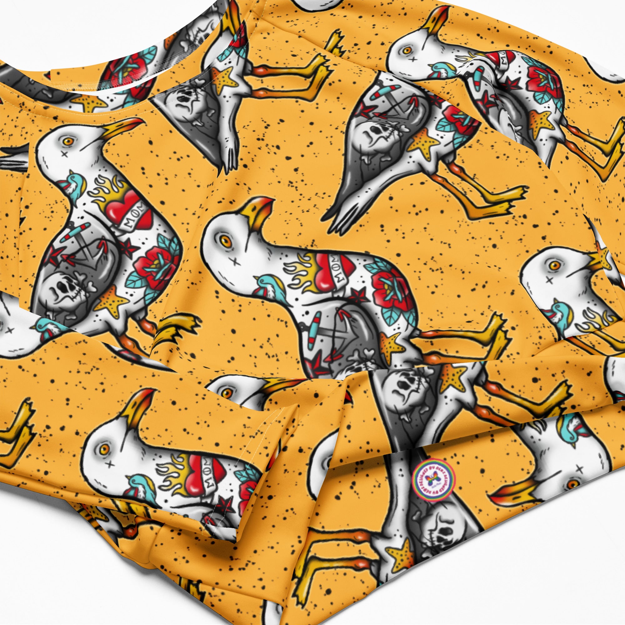Yellow Nautigul Seagulls recycled long-sleeve crop top rash guard with all-over seagull print, designed for active water sports.