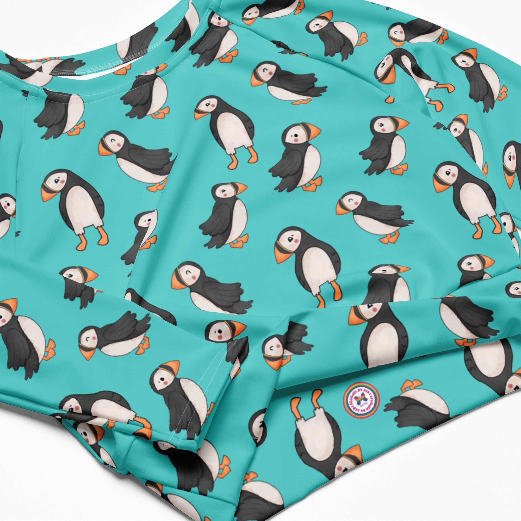 White Puffin Recycled Long-Sleeve Crop Top Rash Guard with all-over print, made from eco-friendly recycled materials.