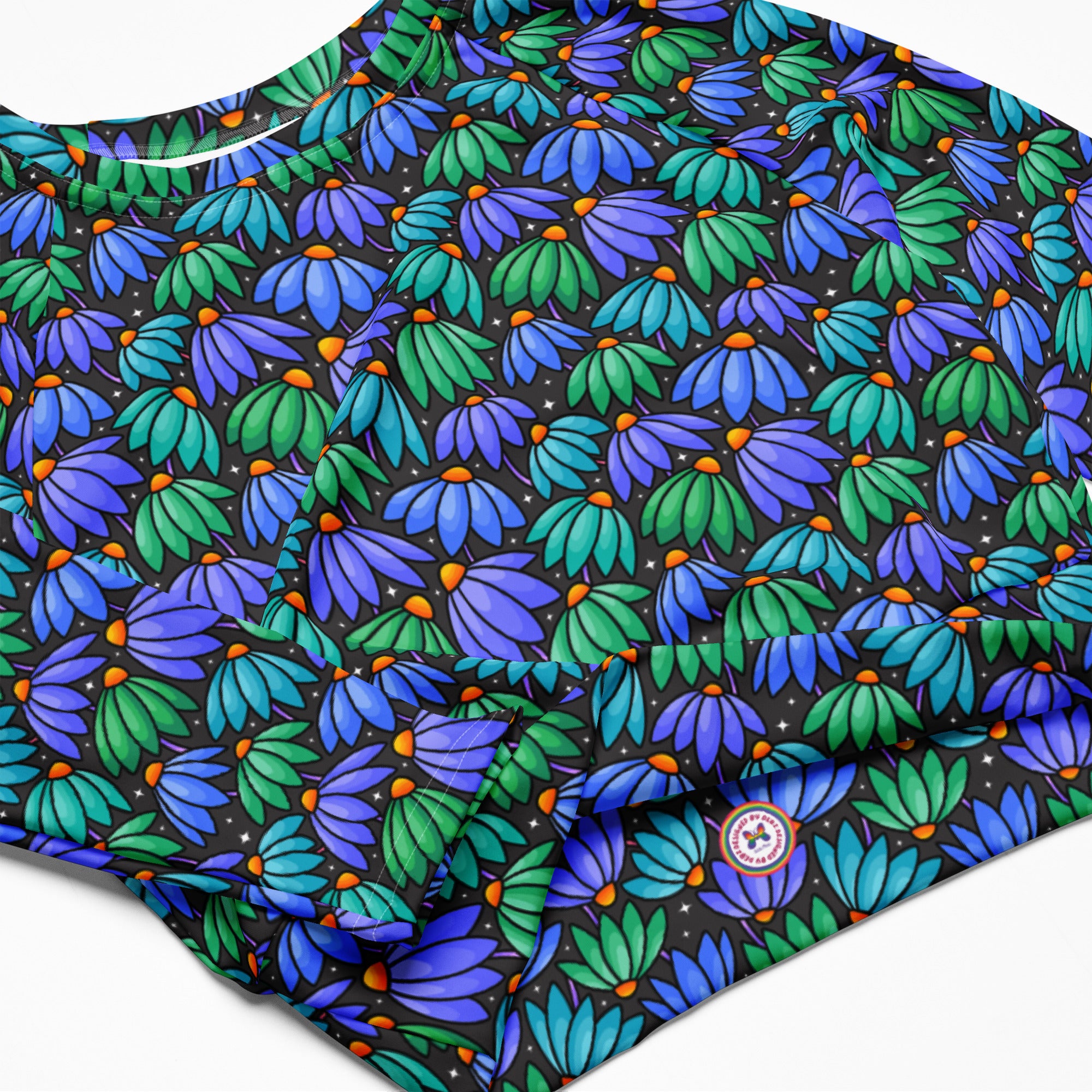 White Floppy Flowers recycled long-sleeve crop top rash guard with all-over floral print, designed for sun protection and style.