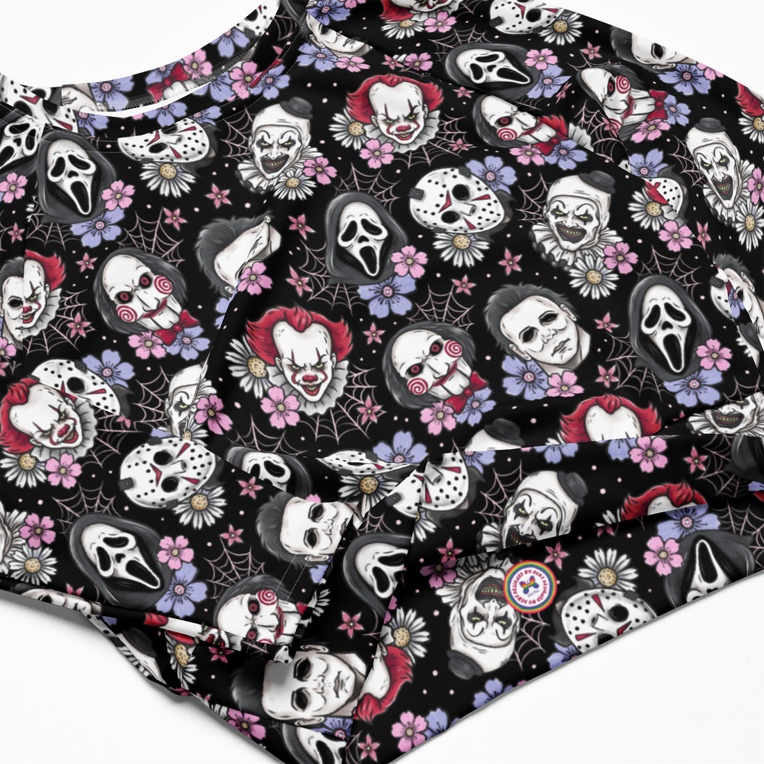 Black horror characters printed long-sleeve crop top rash guard by Printful, featuring all-over spooky design on a white background.