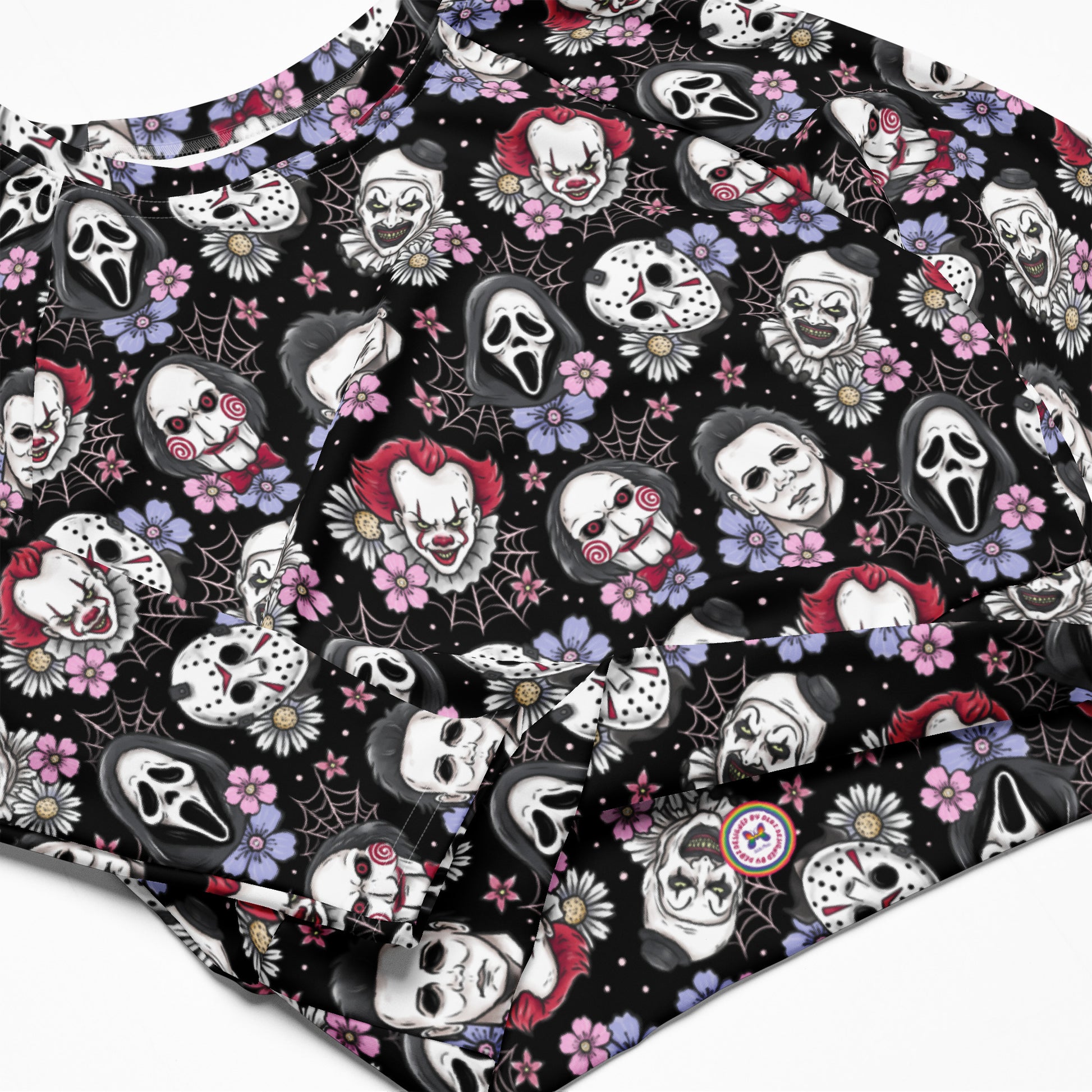 Black horror characters recycled long-sleeve crop top rash guard with all-over print, featuring spooky designs on a white background.