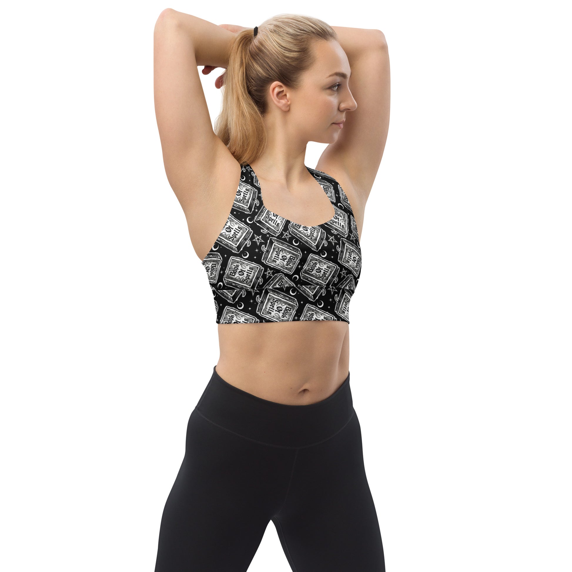 Recycled white longline sports bra by Printful featuring all-over spell book print, designed for active wear and comfort.