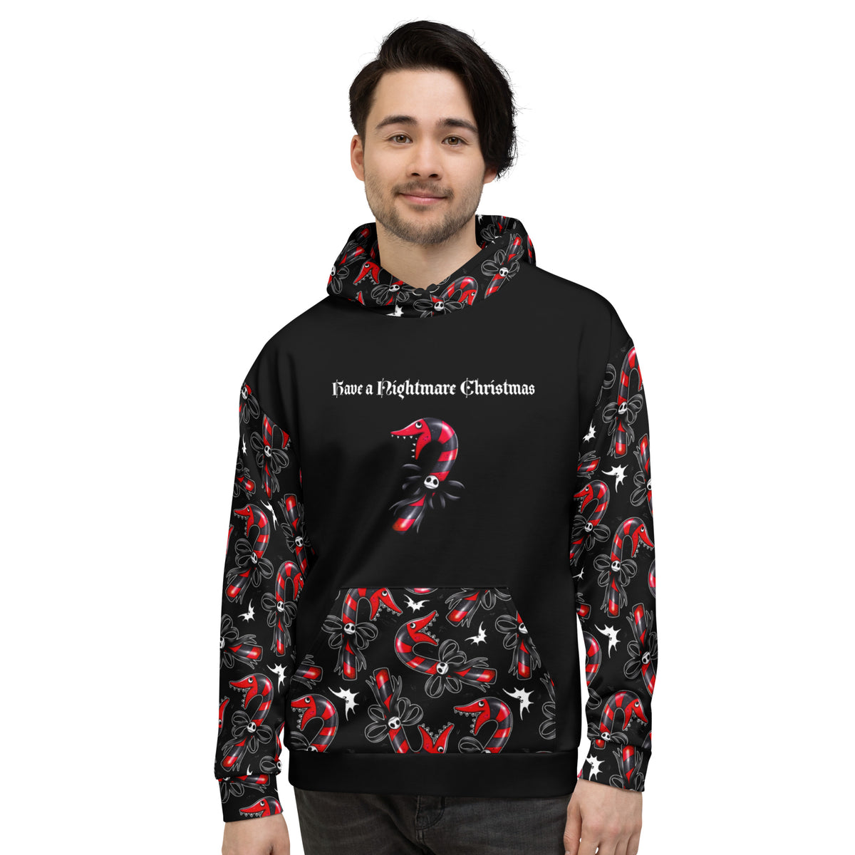 A man wearing a black hoodie with a 'Save a Nightmare Christmas' graphic and red-and-black candy cane patterns on the sleeves, hood, and front pocket, shown against a plain white background.