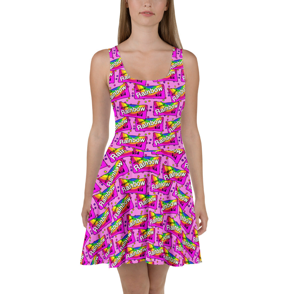 White rainbow print skater dress by Designed By Debz, featuring an all-over colorful pattern and a fitted, flared silhouette.