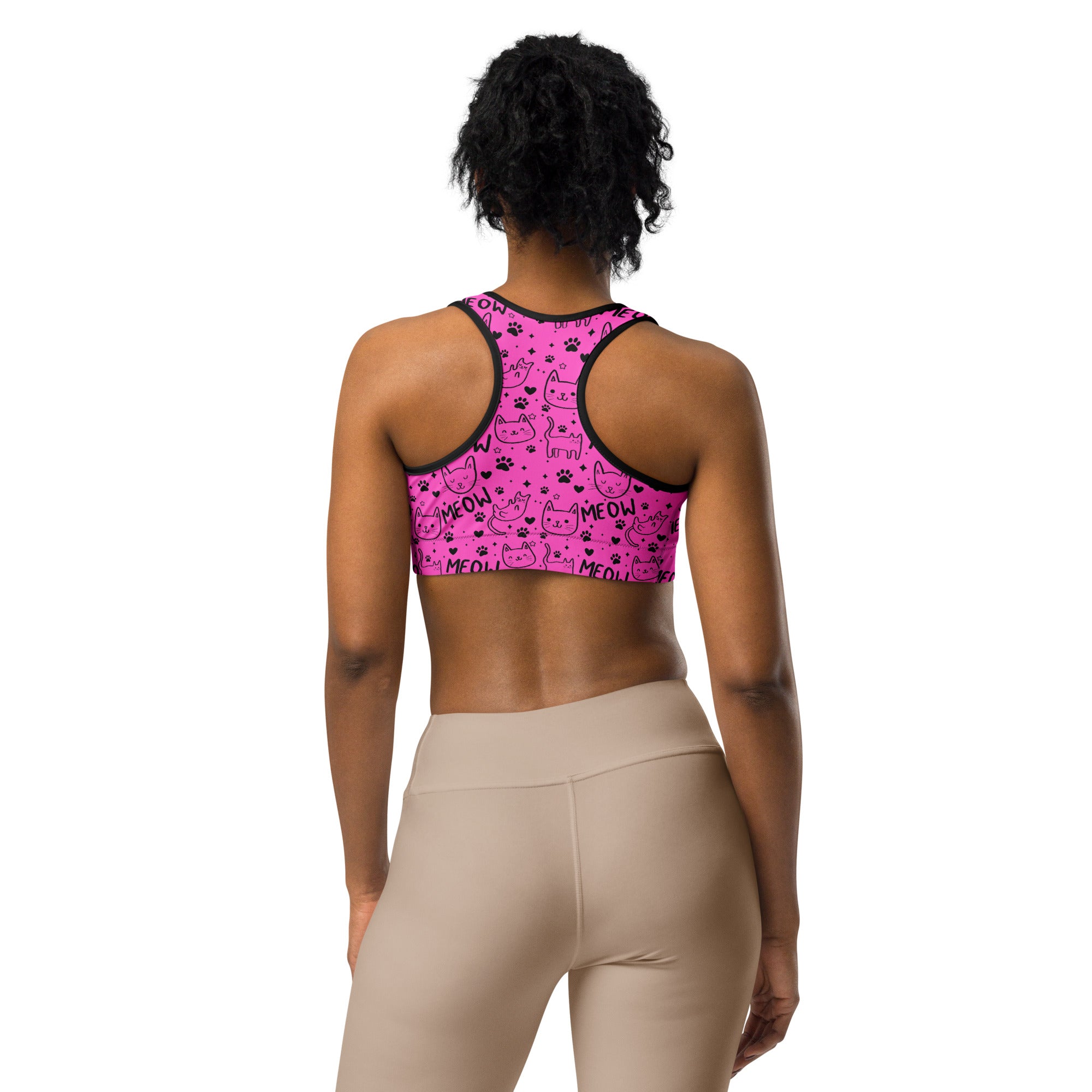 Pink and black cat print sports bra by Printful, all-over design with a supportive fit, viewed from the back.