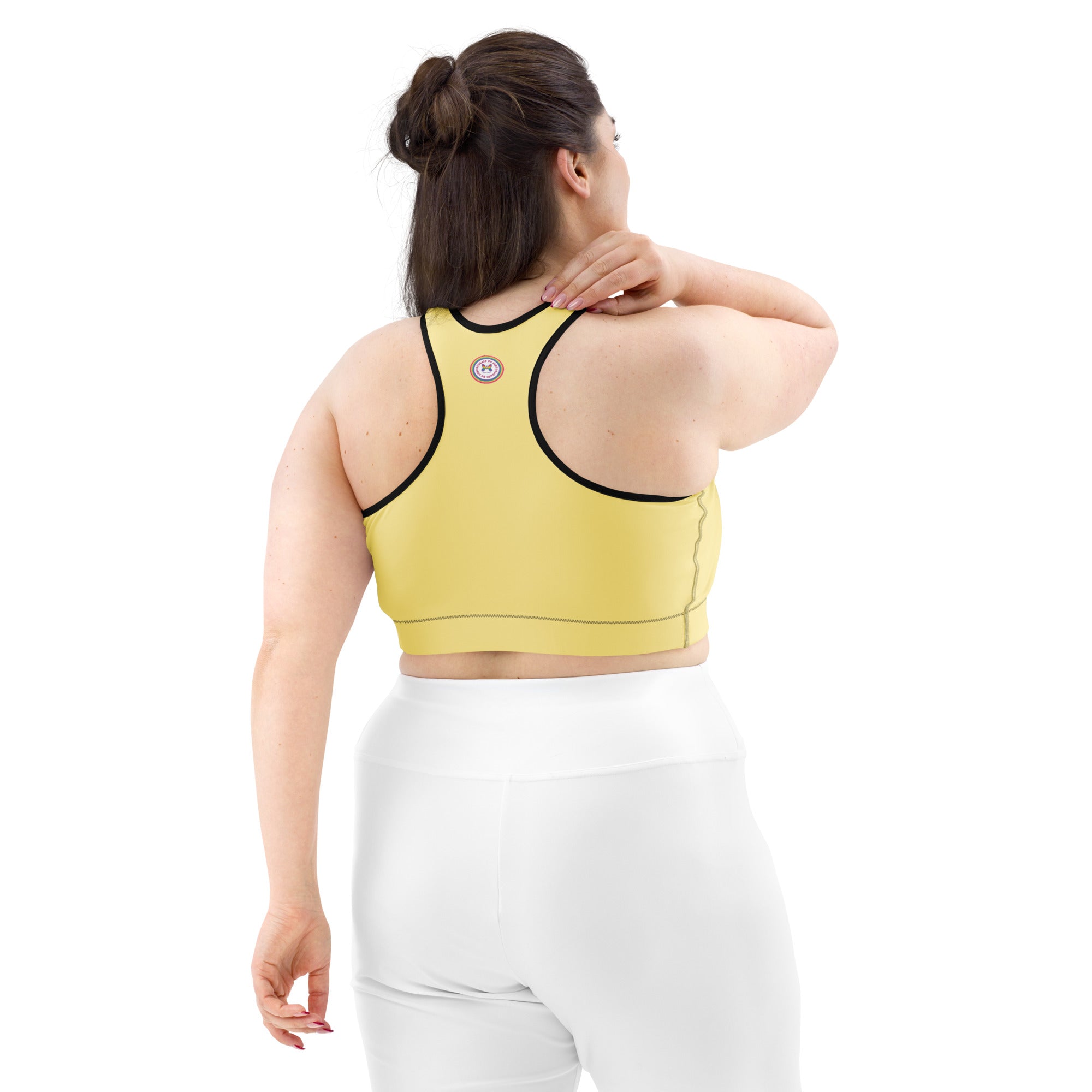 Yellow sports bra with black or white binding, all-over print, featuring a stylish design on the back, from Printful.