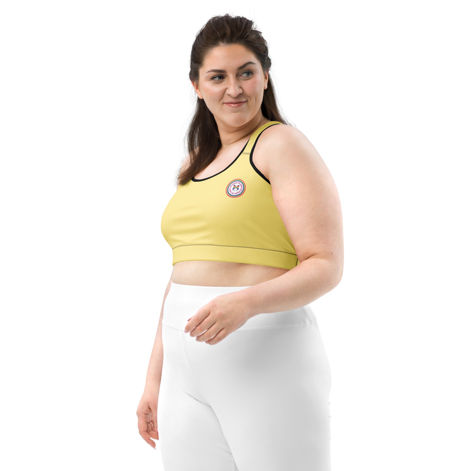 Yellow sports bra by Printful with black or white binding, all-over print, front view, available in XS to 2XL.